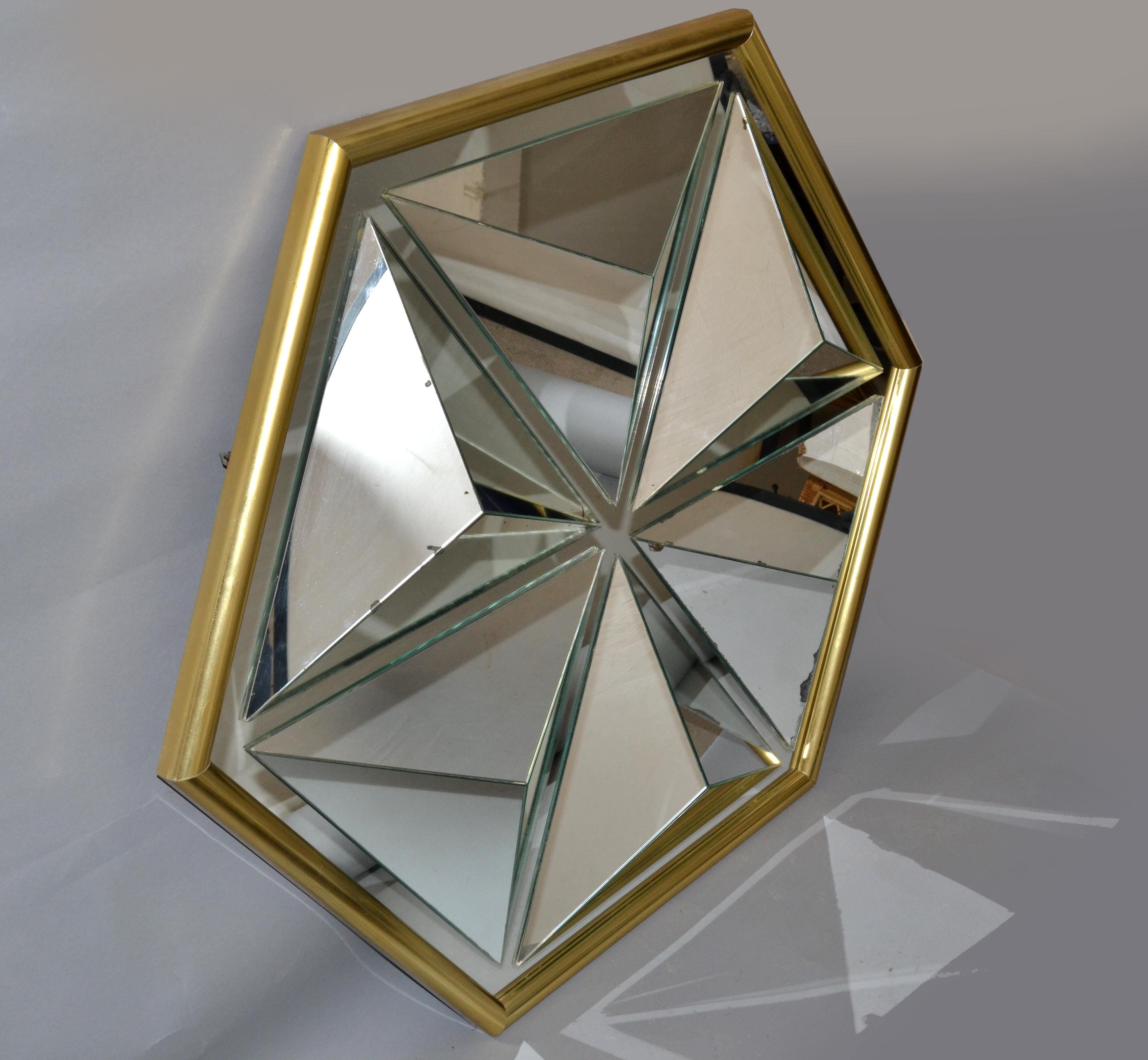 One of a kind diamond shaped faceted wall mirror made in the USA in the 1976.
Hand painted gold finish frame.
Mid-Century Modern design for any interior.
Secure hanging construction and supported by the wood backboard.