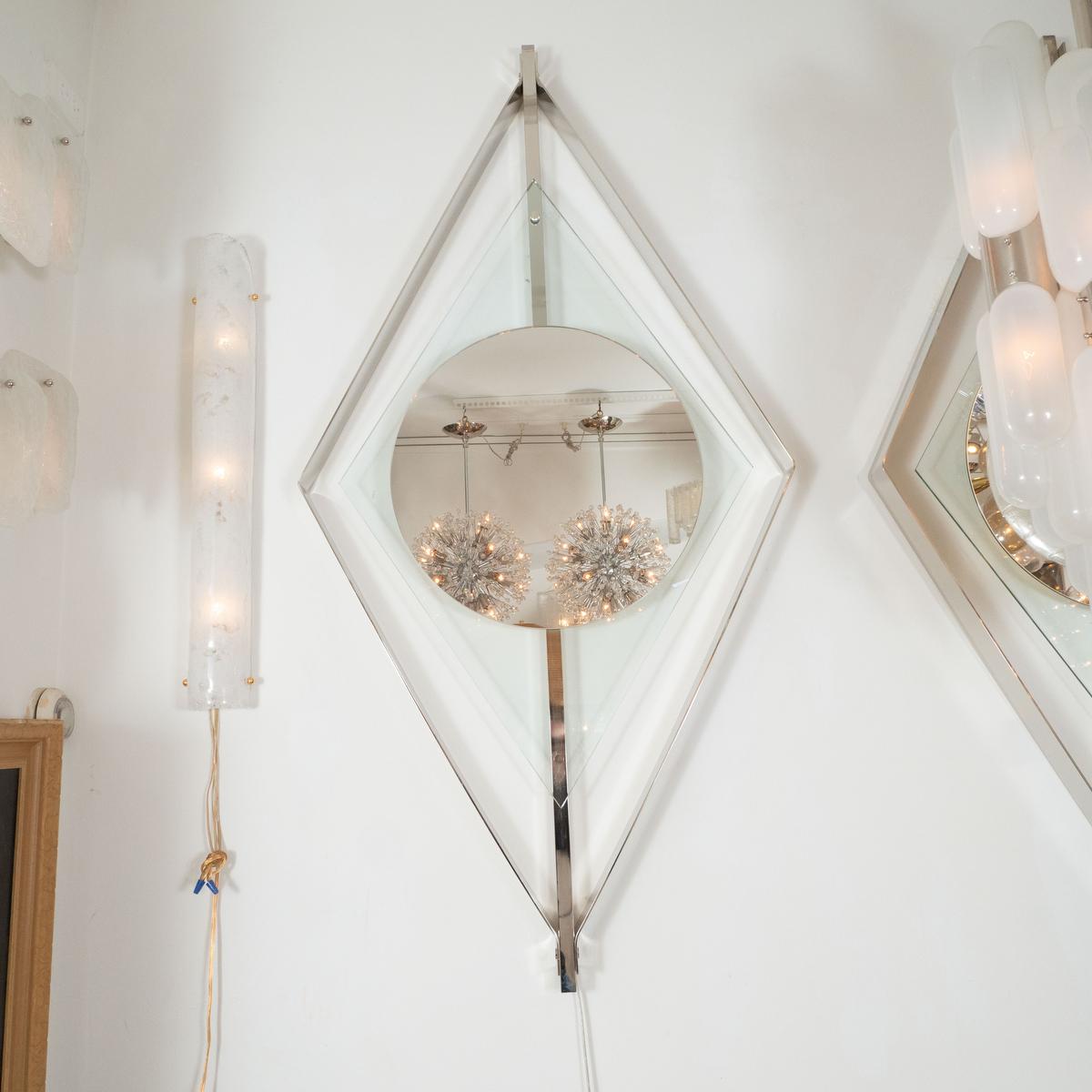 Polished nickel and clear glass floating surround mirror.