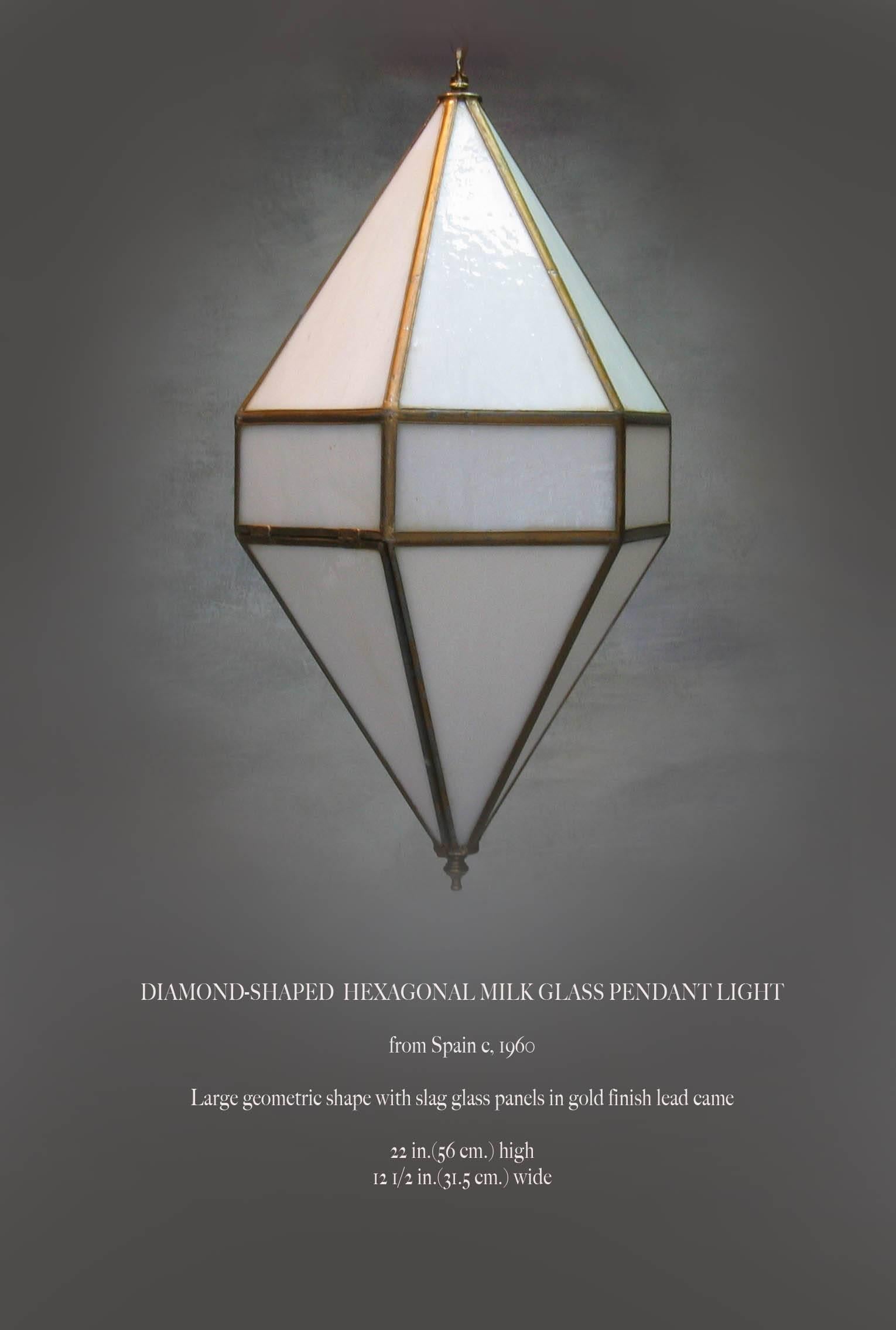 Diamond shaped hexagonal milk glass pendant light, from Spain, 1960. A large geometric shaped light with white slag glass panels with a gold finish lead came. The pendant measures 22
