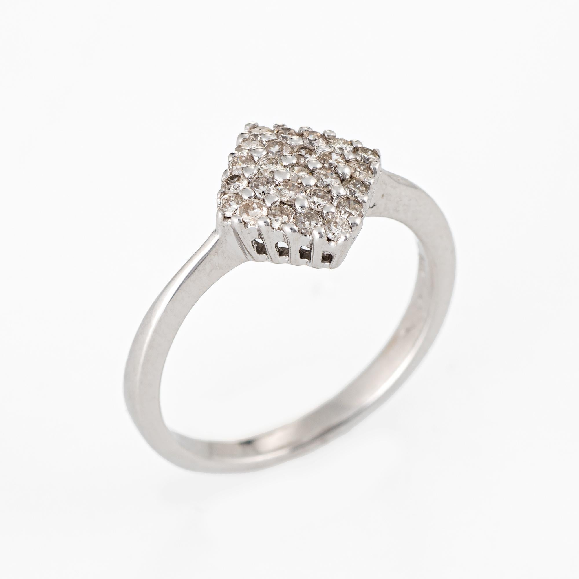 Stylish estate pave diamond ring crafted in 14 karat white gold. 

25 round brilliant cut diamonds total an estimated 0.25 carats (estimated at J color and I1 clarity). 

The diamond shaped mount is slightly concave in design that hugs the finger.