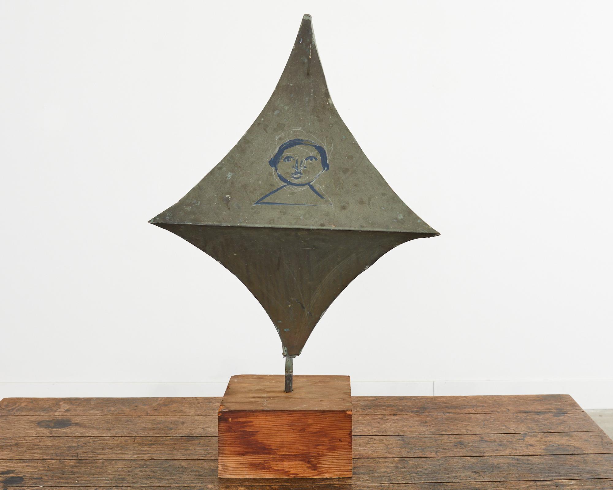 Fascinating objet d'art created and painted by artist Ira Yeager (American 1938-2022). Crafted from patinated zinc with an aged patina and verdigris. The four-sided diamond shape is mounted to a wooden square pine plinth. Each side has a painted
