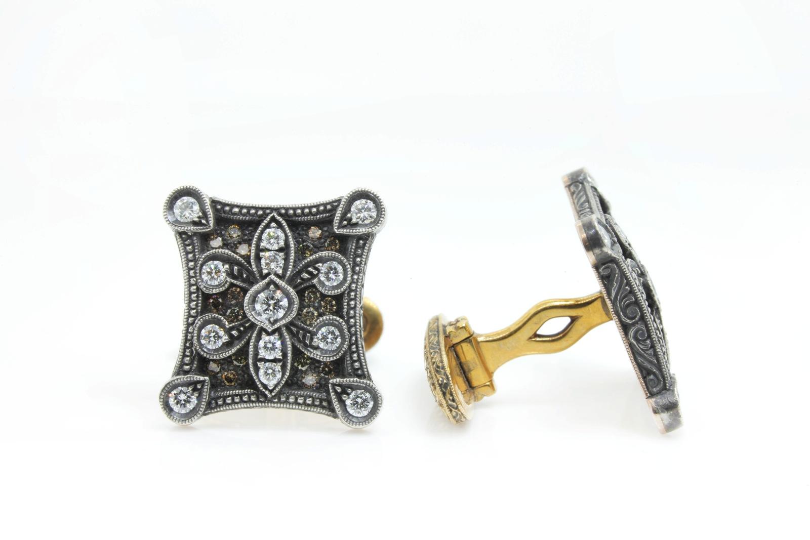 Creatively handcrafted Silver topped 18KT yellow gold Fleur-de-lis  designed cufflinks.   A 1.79 carats of white and natural brown Round Brilliant Cut Diamonds beautifully accent the cufflinks.