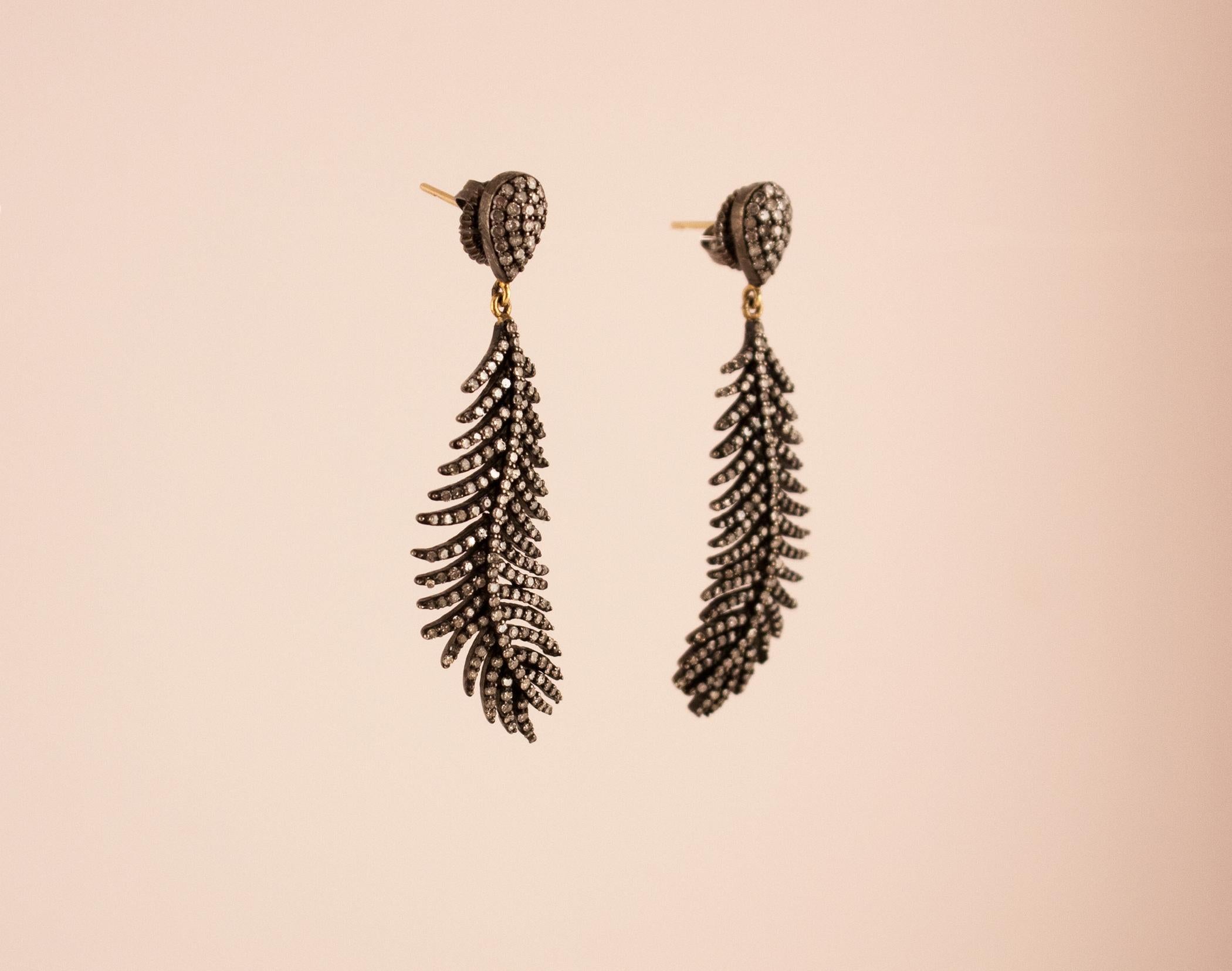 These dangling feathers, or ferns, feature diamonds set in oxidized sterling silver. The dark silver setting gives the earrings an art deco appeal.
Diamond: 3.04 ct
 