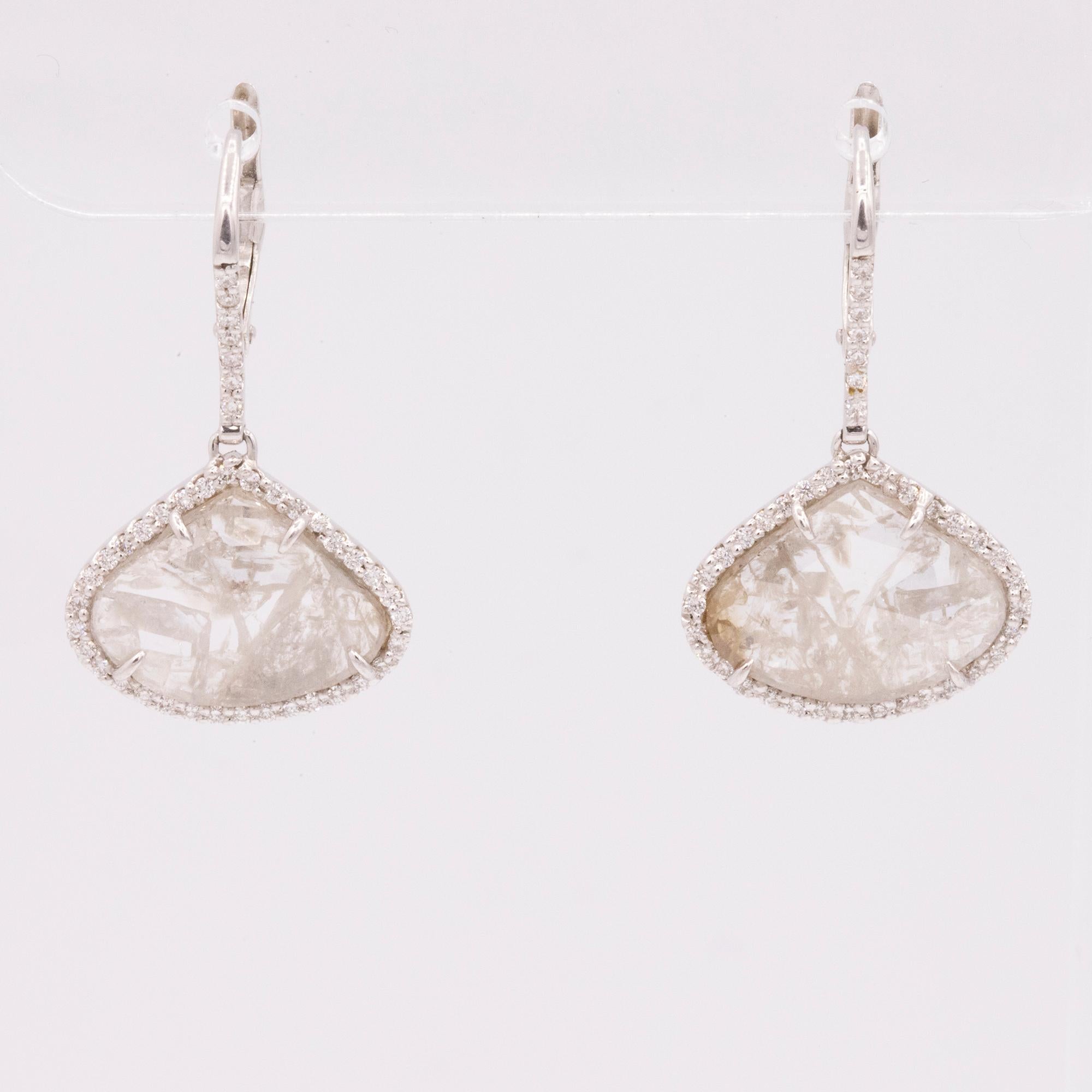 These beautiful handmade drop earrings feature two diamond slices that weigh 6.30 carats total. Accented with 72 pave set round diamonds that are also on the front on the ear wire, weighing .30cts total. Crafted in 18k white gold. French wires. 28mm