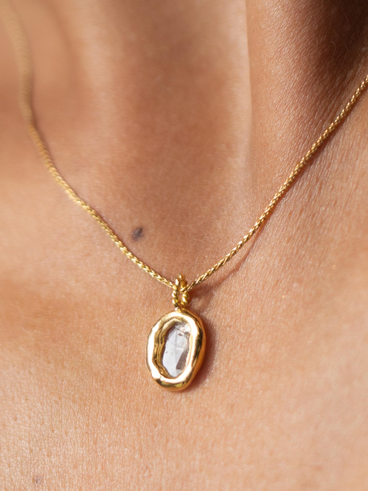 True to her name meaning “precious” the Alaine Necklace feels dainty and unassuming but is utterly eye catching in certain light. Highlighting a natural rose-cut diamond slice, this pendant hangs from a silky 14 karat vintage style wheat chain. Wear