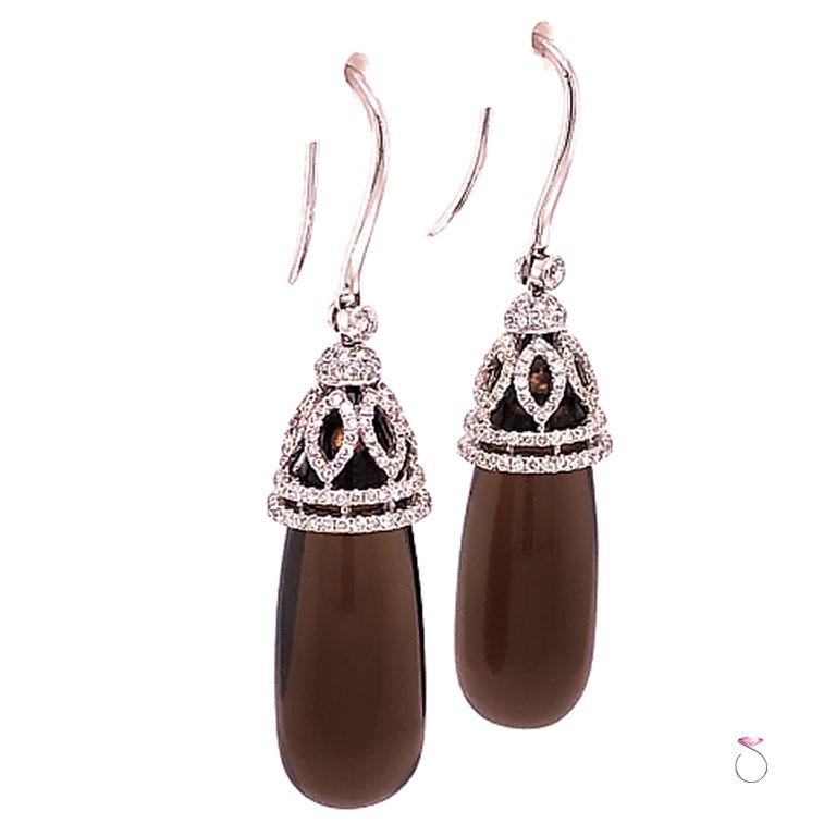 Magnificent Smoky Quartz & Diamond drop earrings in 18k white gold. These beautiful earrings feature two large drop pear shape Smoky Quartz gems totaling 20.43 carats. The Smoky quartz are set in a 18k white cap set with diamonds. The diamond set