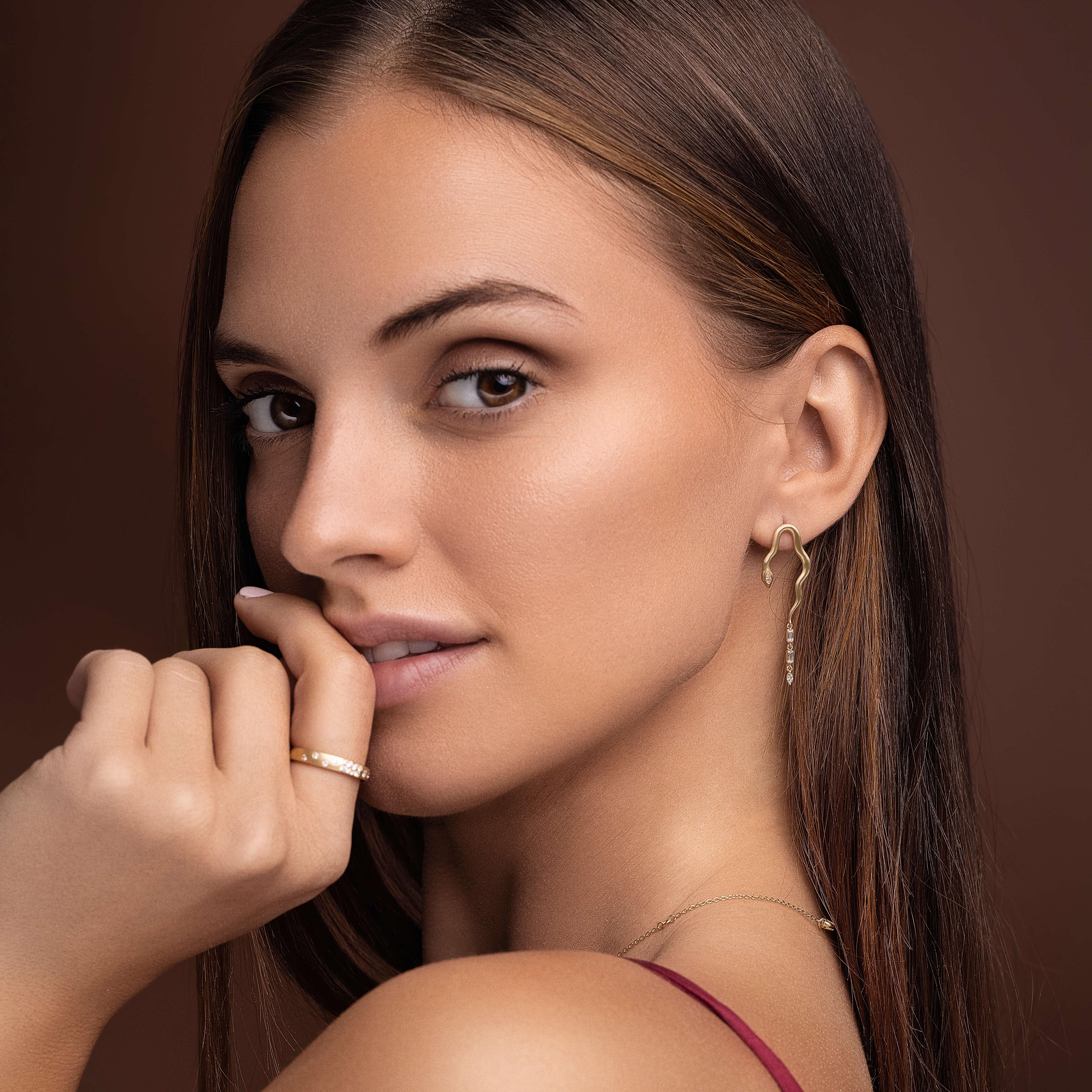 Featured in British Vogue, these 14k gold snake earrings have a beautiful satin finish. Each earring features 2 diamond baguettes and 2 diamond marquise for a total of 0.36 ctw. The earring dimensions are 12x40mm. They are affixed with posts.