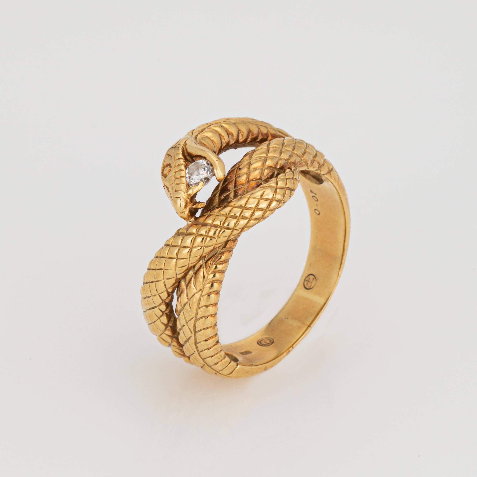 Finely detailed snake ring crafted in 18 karat yellow gold (circa 2000s). 

One estimated 0.07 round brilliant cut diamond is set into the mount (estimated at I-J color and I1 clarity).      

For centuries the snake has represented eternal love and