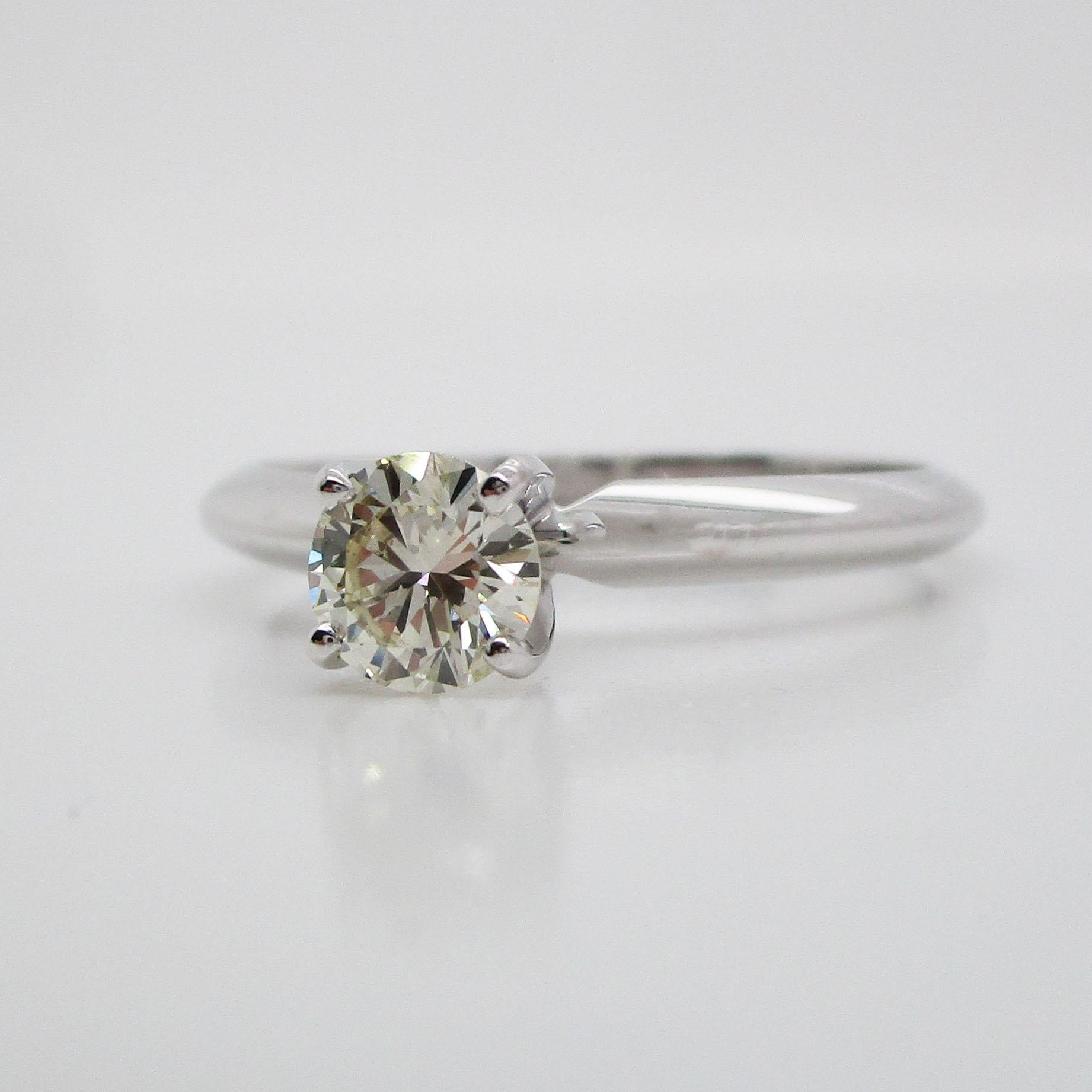 This is a beautiful classic solitaire engagement ring in 18k white gold. This is the ideal ring for the woman who craves the classic, traditional look! 
This ring is a size 6 but can be resized upon request. 
The center diamond is 0.66 carats. It is