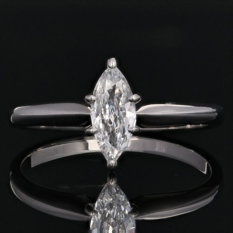 Shining like the resplendent beauty of your cherished romance, this spectacular engagement piece will be the perfect choice for your sweetheart! This 14k white gold ring cradles a marquise cut diamond solitaire in a raised six-prong mount above the