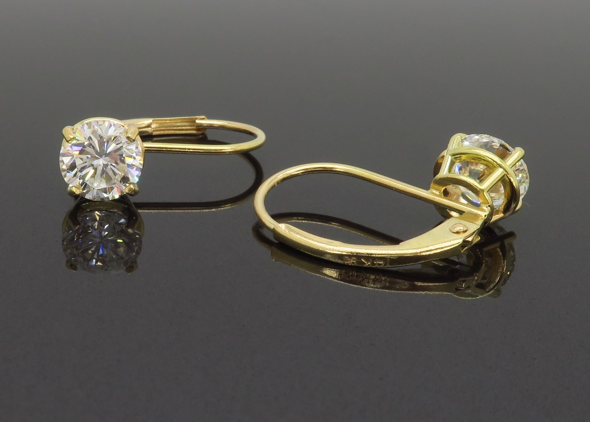 These beautiful lever back diamond solitaire earrings are made with Round Brilliant cut diamonds set into 14k yellow gold. 

Carat Weight: Approximately 1.28CTW
Diamond Cut: Round Brilliant Cut Diamonds
Average Diamond Color: G-H
Average Diamond