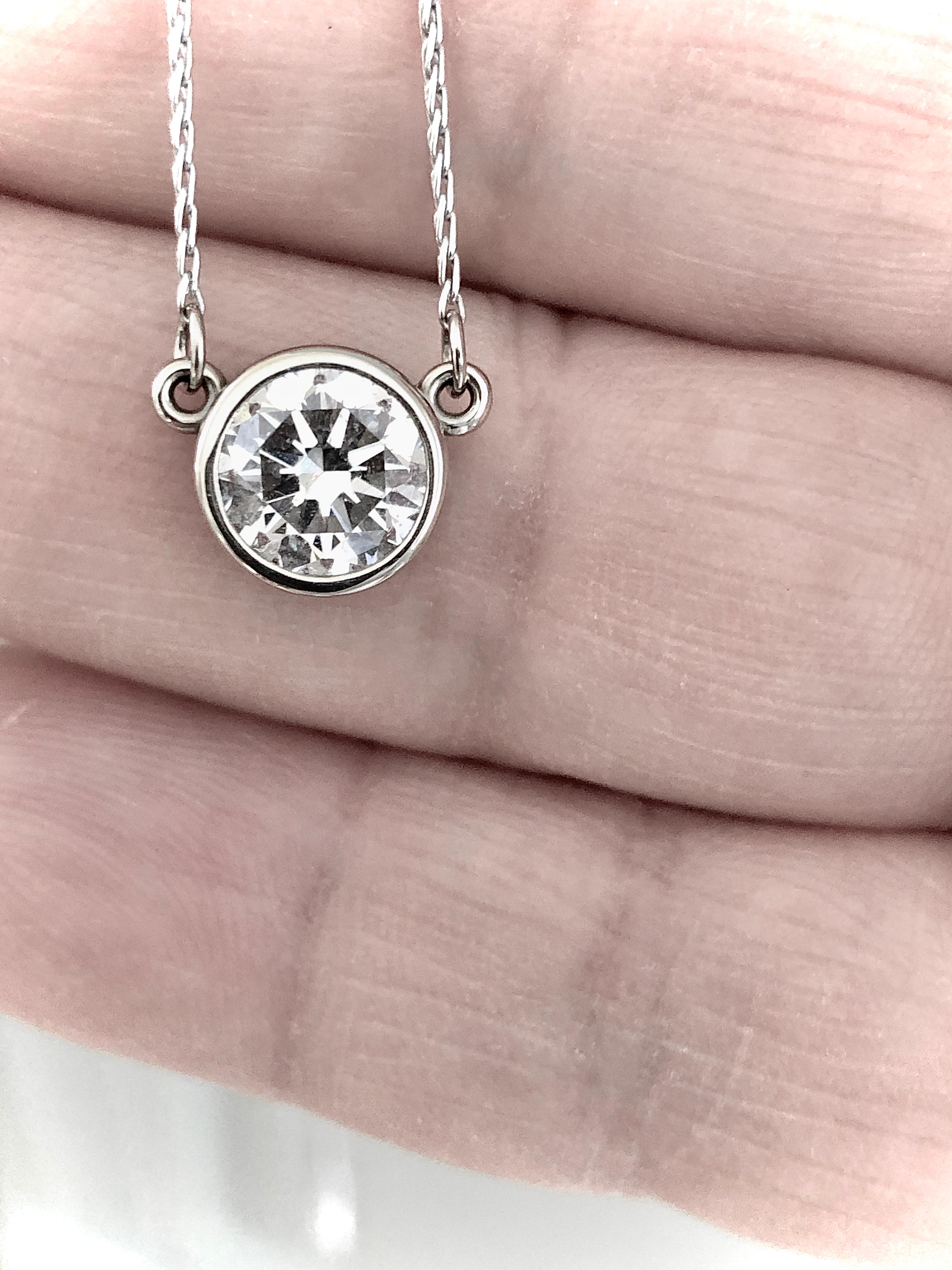 1.50 carat bright sparkly round brilliant cut diamond pendant necklace. Face up white with just a hint of color. 1 Round Brilliant cut  J- SI1 diamond,  1.50 carat (7.16mm).  14k white gold  3.4 grams. Chain: 18.25 Inches
Natural Diamond 
Average