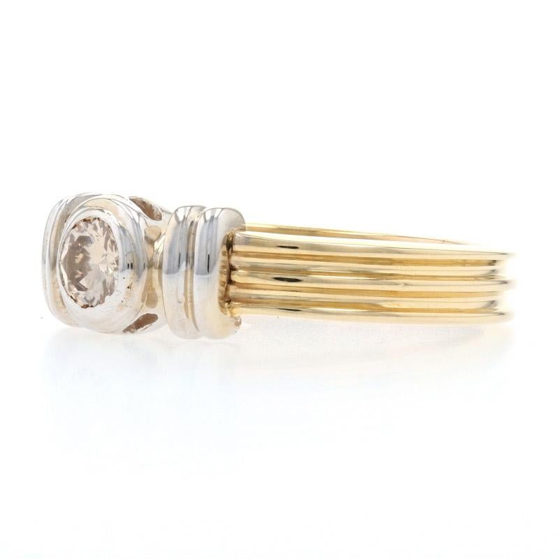 This gorgeous ring will be a dazzling addition to your day or evening ensembles! Fashioned in classic 14k yellow and white gold, this sophisticated ring showcases a ribbed band design that is adorned with a sparkling champagne brown diamond held in