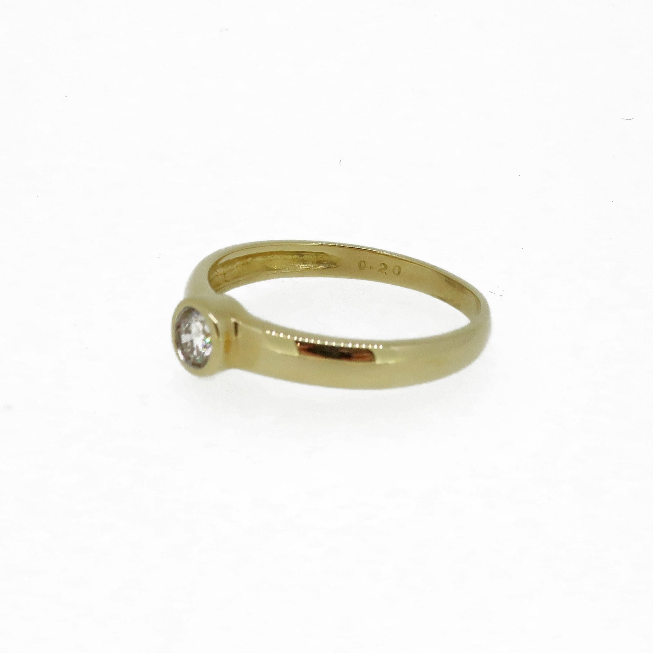 Diamond Solitaire Ring 18 Karat Yellow Gold

A delicate brilliant cut diamond solitaire ring. The round brilliant cut diamond encased in a rub over setting, on the band style shank all 18ct yellow gold. The shank is stamped with the diamond weight