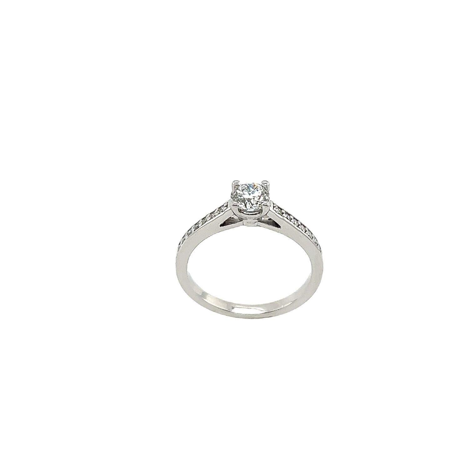 This gorgeous classic solitaire diamond ring set with 0.51ct G/SI2 round brilliant cut diamond IGI certified in 14ct white gold with 14 small diamonds on the shoulders,0.12ct can make a perfect engagement ring for a bride or a birthday present for a
