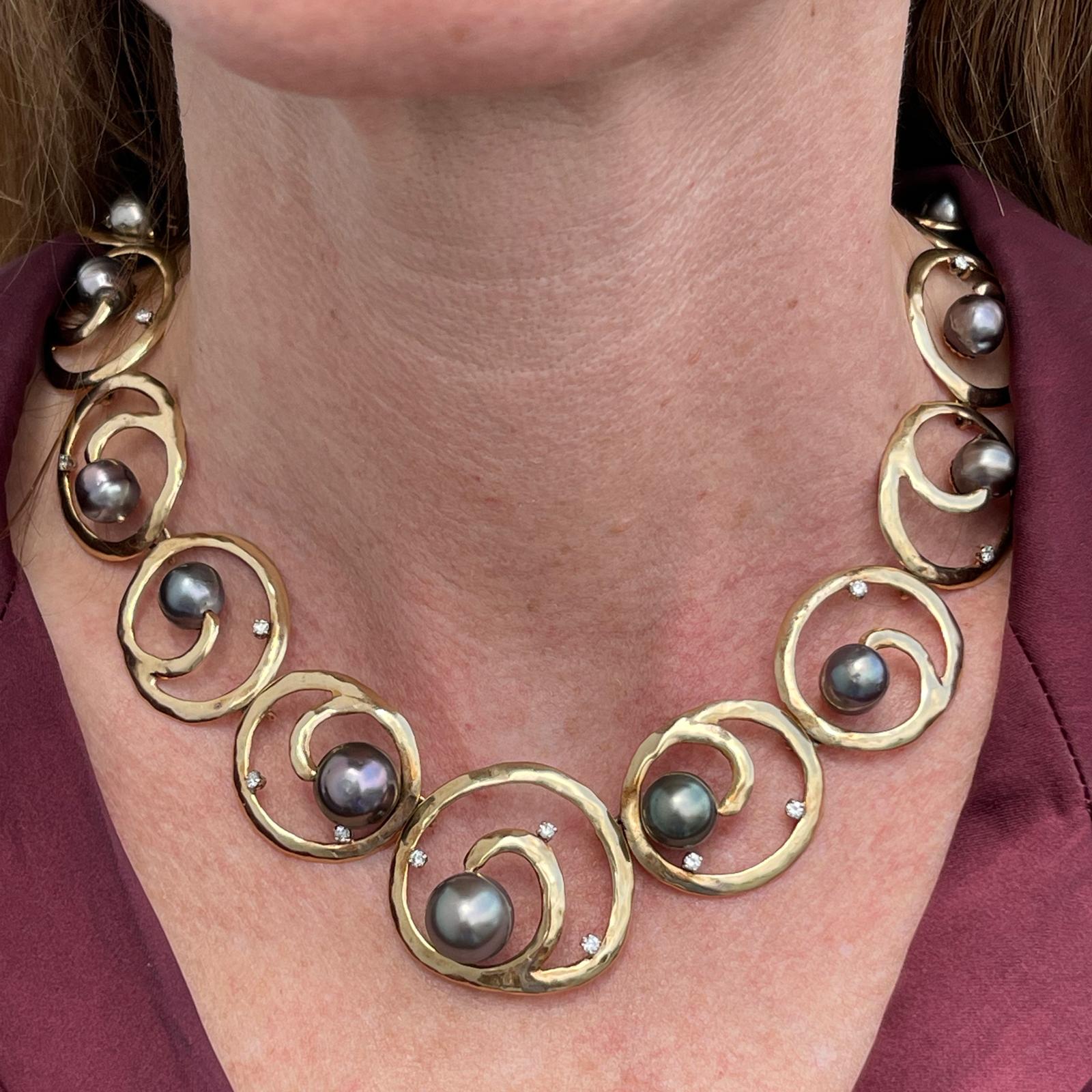 South Sea pearl and diamond necklace handcrafted in 14 karat yellow gold. The open circle links feature 21 round brilliant cut diamonds and 17 South Sea pearls. The diamonds weigh approximately .75 CTW and are graded G-H color and SI2 clarity. The