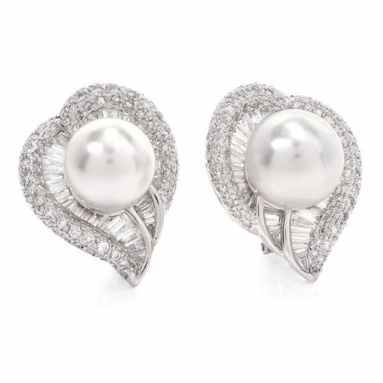 These elegant pair of South Sea Pearl & Diamond fancy heart cluster earrings are crafted in solid 18K white gold. These fashionable earrings displays a fancy heart shape design centered with 2 genuine South Sea Pearls with natural blemishes approx:
