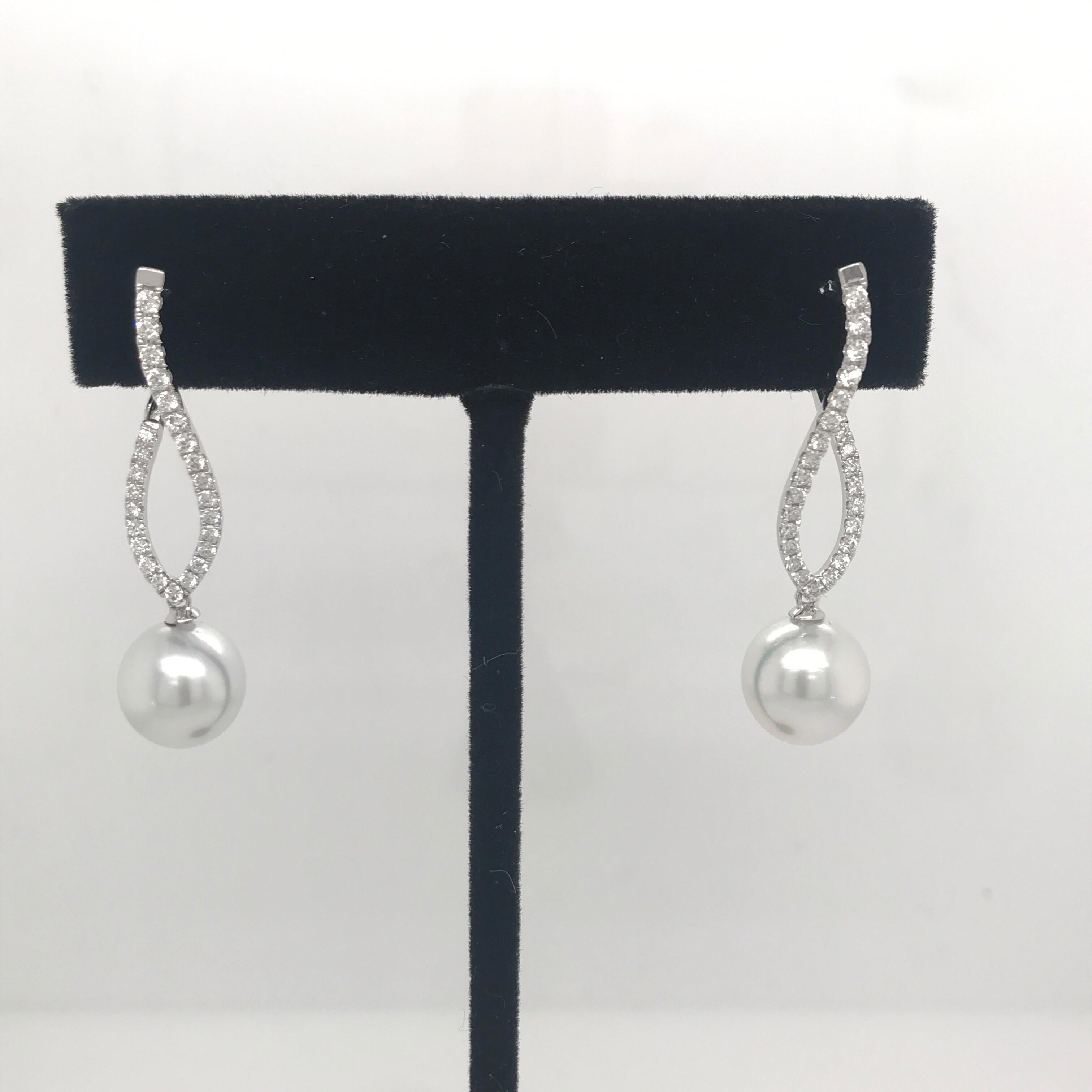 18K White Gold drop earrings featuring 50 round brilliants weighing 0.70 carats with two South Sea Pearls measuring 10-11 MM. 
Fits perfectly on the ear!

Available in all gold & pearl colors. 