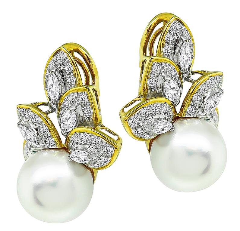 This is an elegant pair of 18k yellow and white gold earrings feature sparkling marquise and round cut diamonds that weigh approximately 4.25ct. graded G-H color with VS clarity. The earrings measure 30mm by 28mm and weigh 24.5 grams. They are