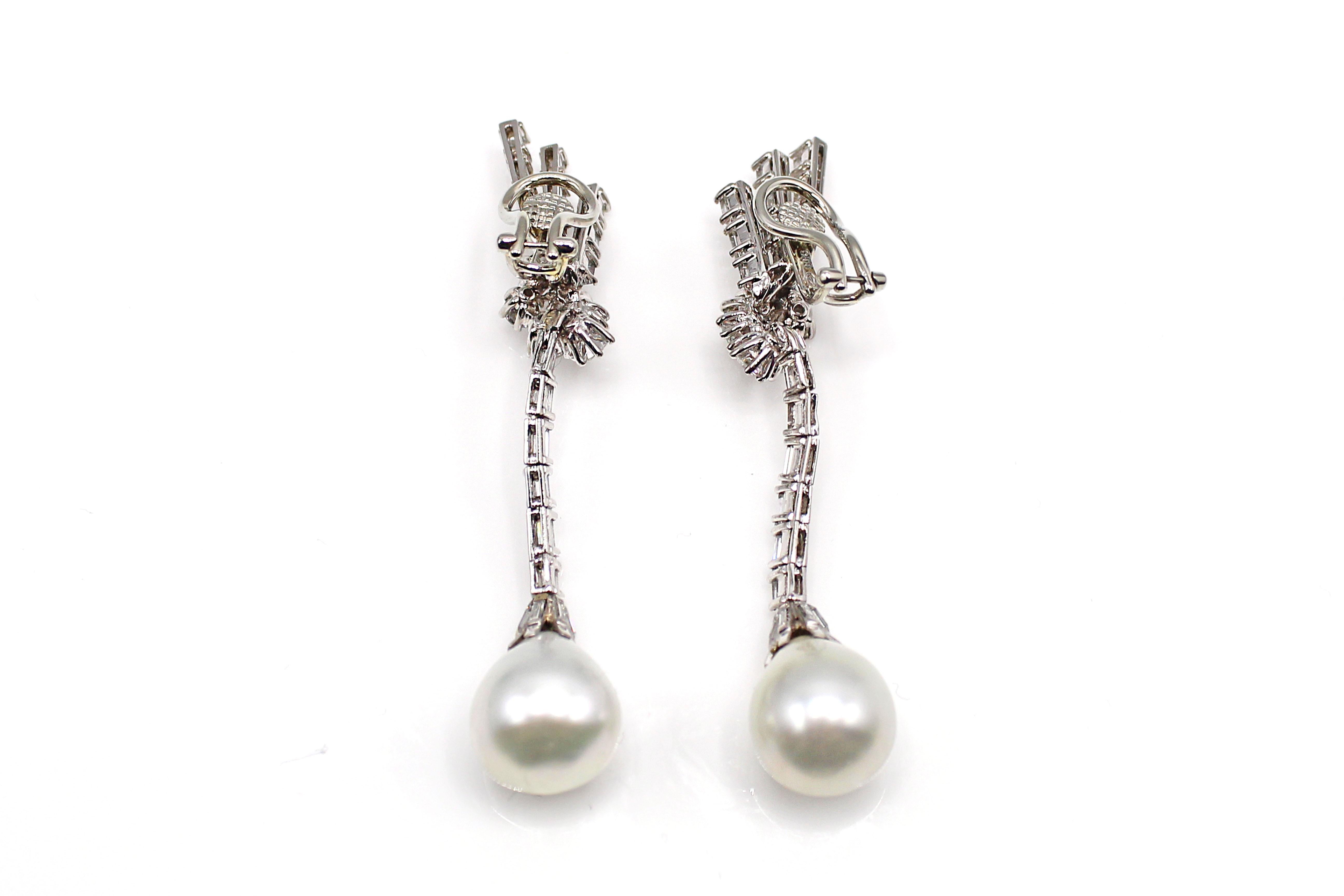 A pair of perfectly matched 13 mm bright white and lustrous South Sea  pearls extend 2 inches from the top of these beautifully hand-crafted earrings. Further embellished by 42 baguette and 12 round brilliant cut bright, white and sparkly diamonds