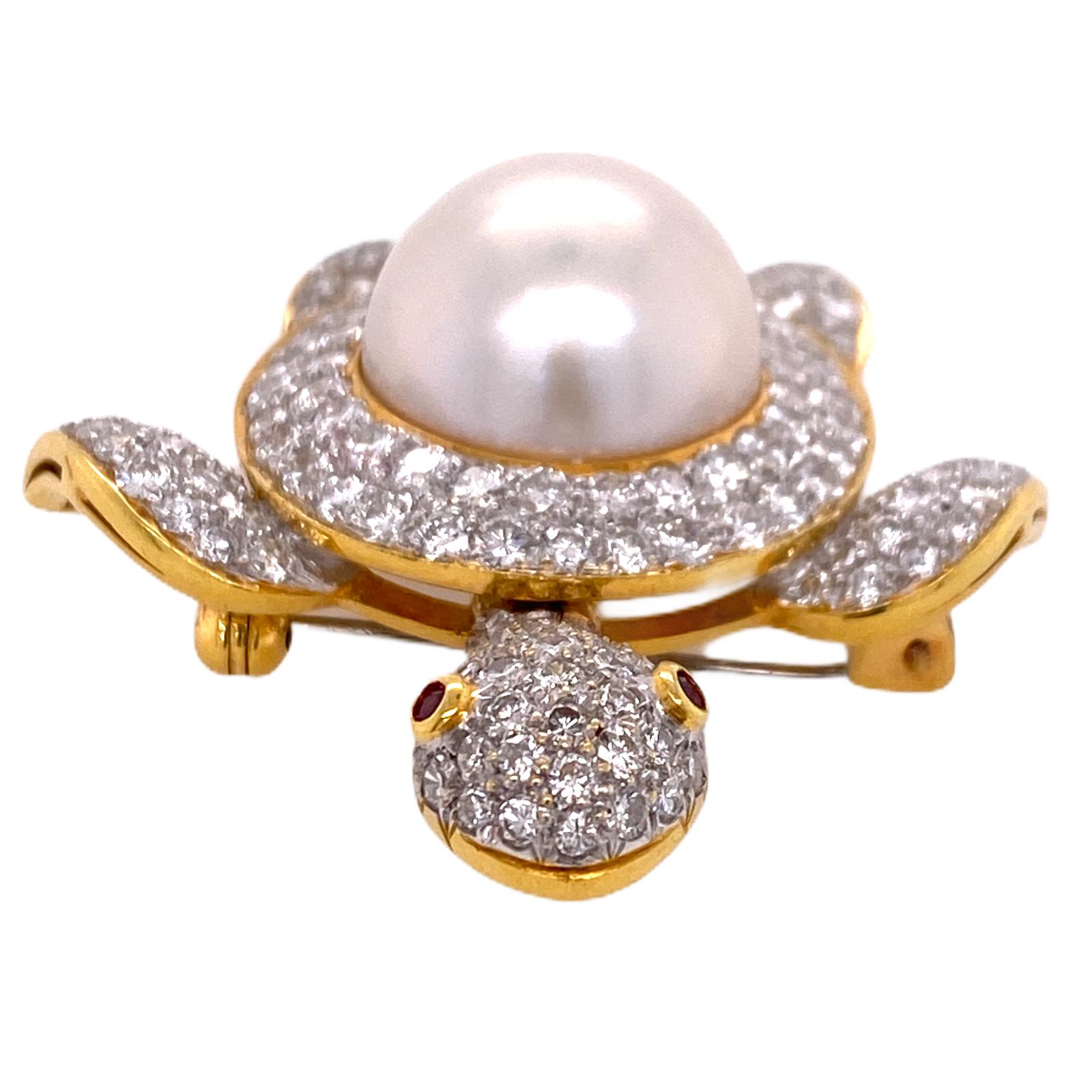 Fabulous diamond and South Sea pearl turtle brooch fashioned in 18 karat yellow gold. The turtle's head moves side to side, the shell is a South Sea Pearl, and the eyes are rubies. The brooch features round brilliant cut diamonds weighing 3.00 carat