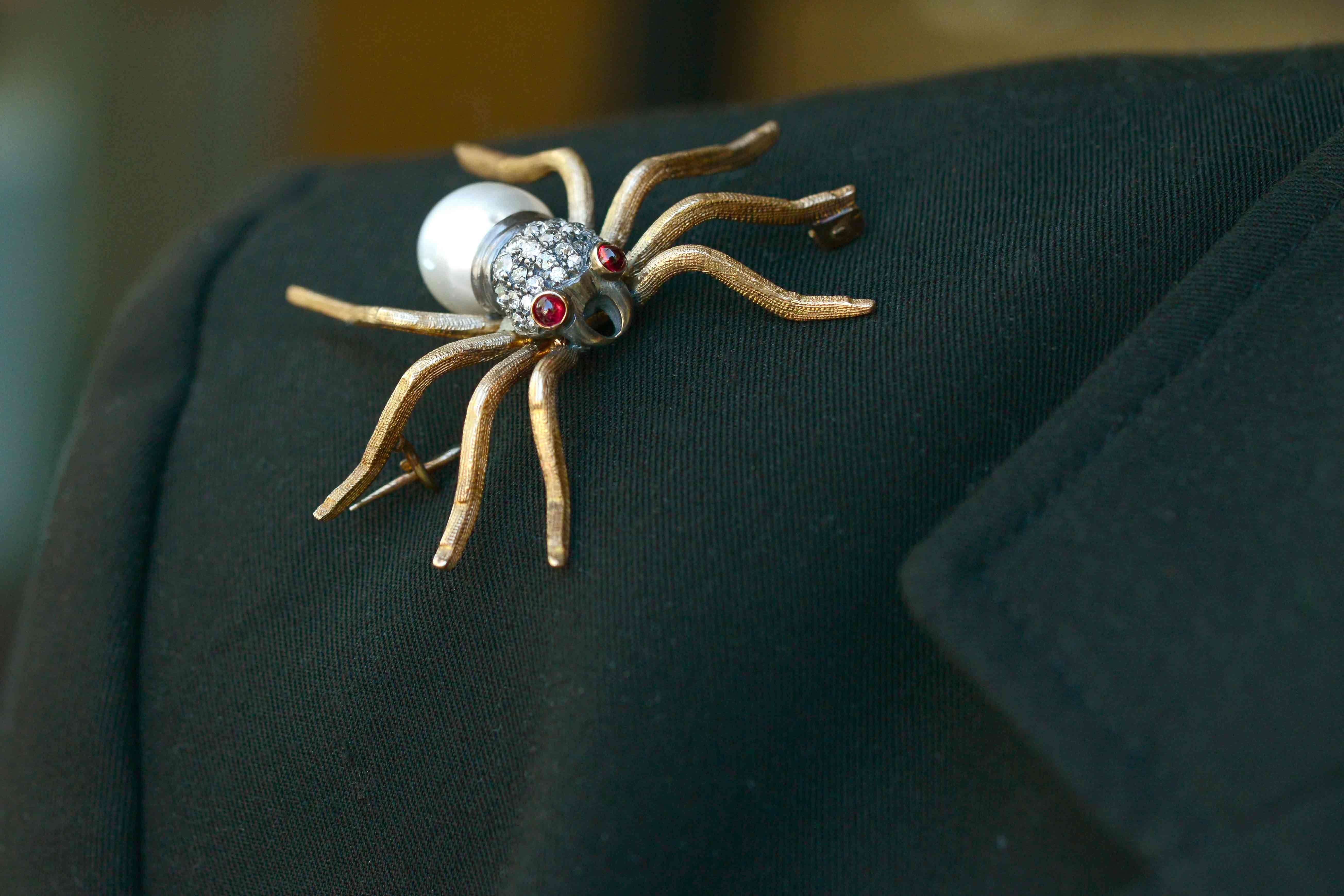 A dramatic diamond spider brooch, this antique Victorian tarantula pin pendant is centered by a luminous, giant South Sea pearl and is studded with twinkling old mine cut diamonds. The entrancing ruby eyes will put people under your spell. Crafted