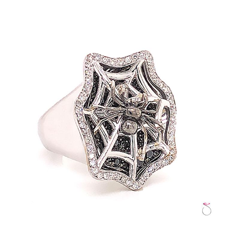 Beautiful white and black diamond spider ring in 18K white gold. This ring is beautifully crafted with magnificent details. The ring features 54 natural round brilliant cut diamonds pave' set around the edge totaling approximately 0.30 ct. A spider