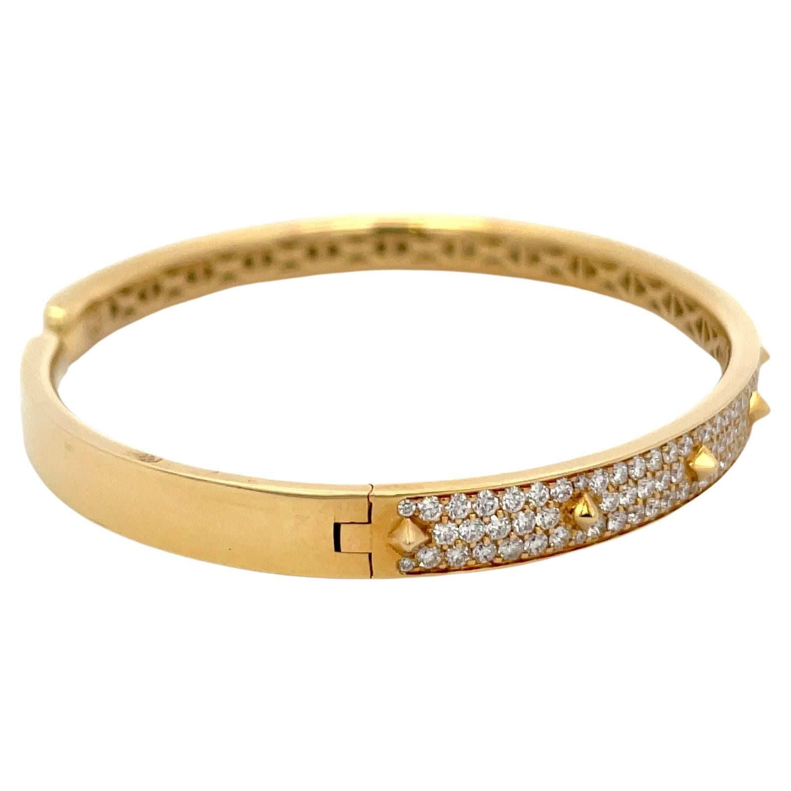 Italian, 18 Karat yellow gold bangle bracelet featuring 3 rows of diamonds and spike motifs weighing 1.75 carats. 
Color F
Clarity VS
Designer: Crivelli Jewelry 

Super cool, great for layering or wear alone! 
Matching Earrings
DM for more videos 