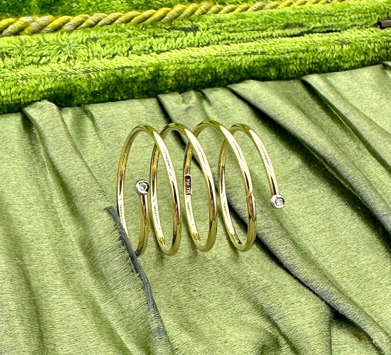 This is a fabulous Diamond Spiral Coil or Snake Ring in 10 Karat Yellow and White Gold.  The wonderful ring spirals around the finger and is set with sparkling diamonds at either end.  The spiral coil design is so delightful!  The spiral is 10 Karat