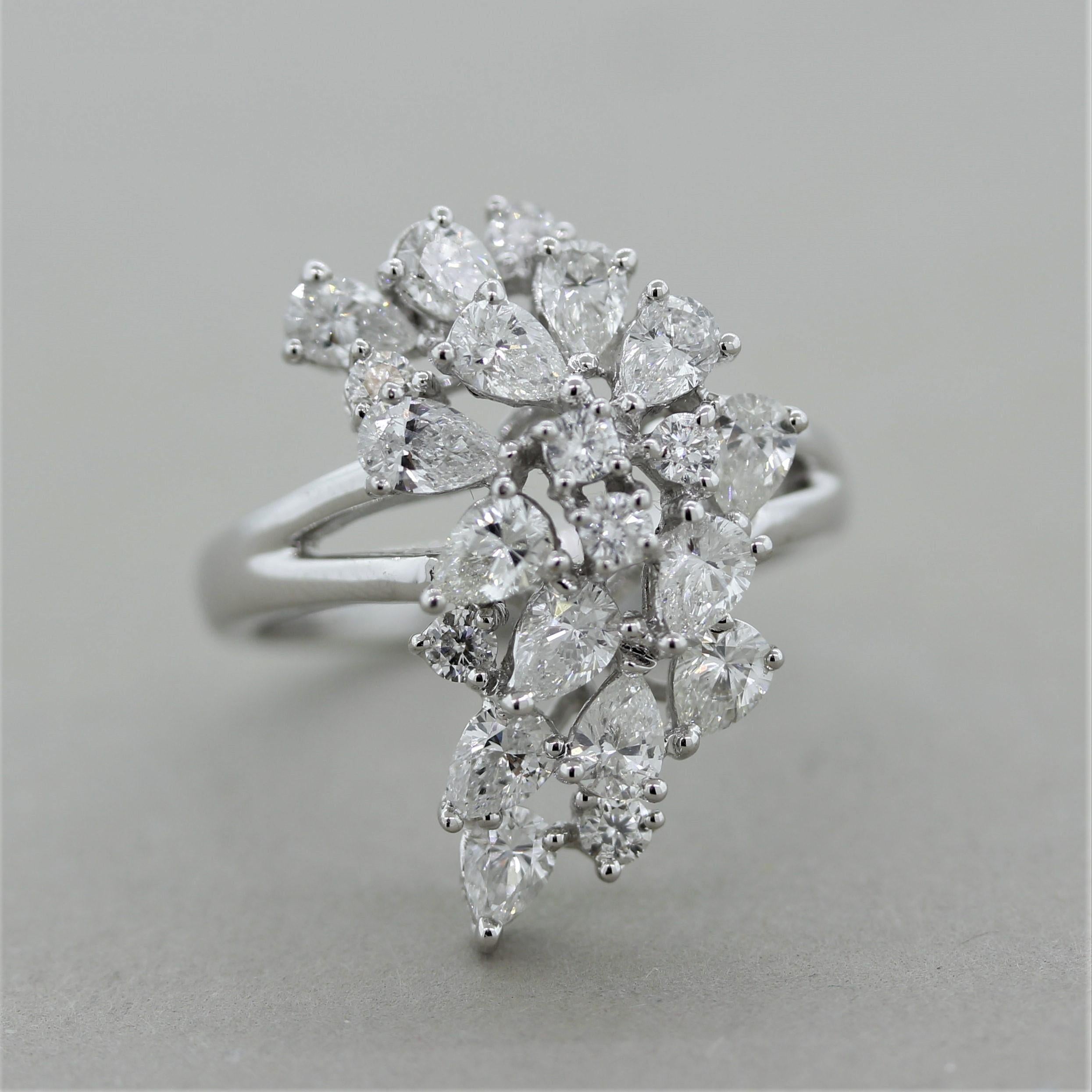 A classic diamond spray ring featuring 2.66 carats of larger diamond which include round brilliant and pear-shaped diamonds. They are set in a cluster/spray pattern in a cascading design. Made in 18k white gold and ready to be worn!

Ring Size 7