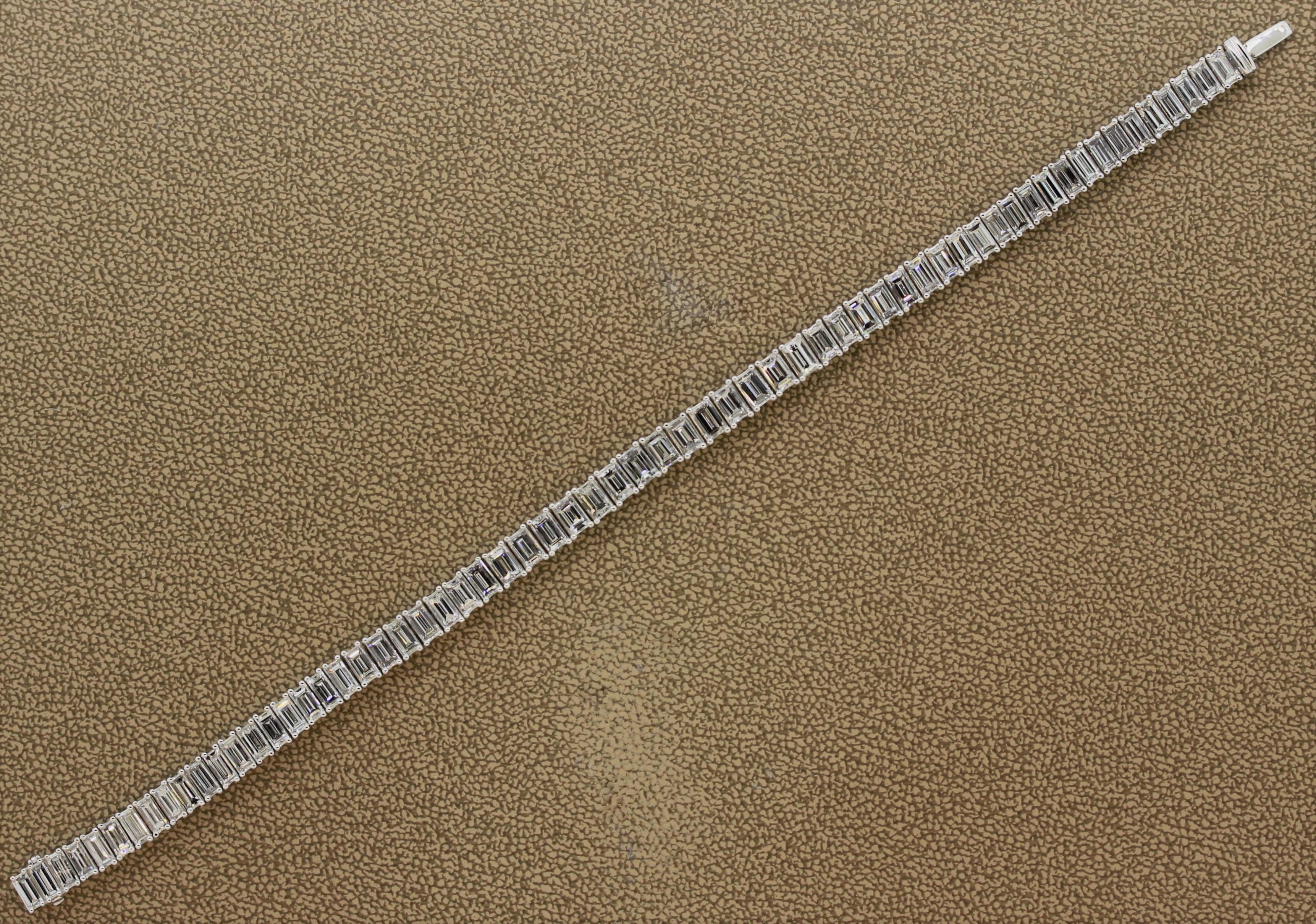 A special tennis bracelet featuring 63 fine square cut diamonds weighing a total of 13.76 carats. They have a clarity of VS2, color of G-H, and weight on average 0.21 carats. The length of the diamonds are 5.35mm. They are hand set in 18k white gold