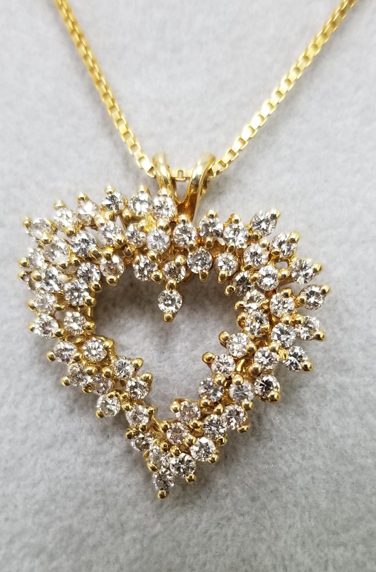 14k yellow gold diamond heart necklace, containing 64 round full cut diamonds of very fine quality weighing 1.30cts. on a 16 inch chain.