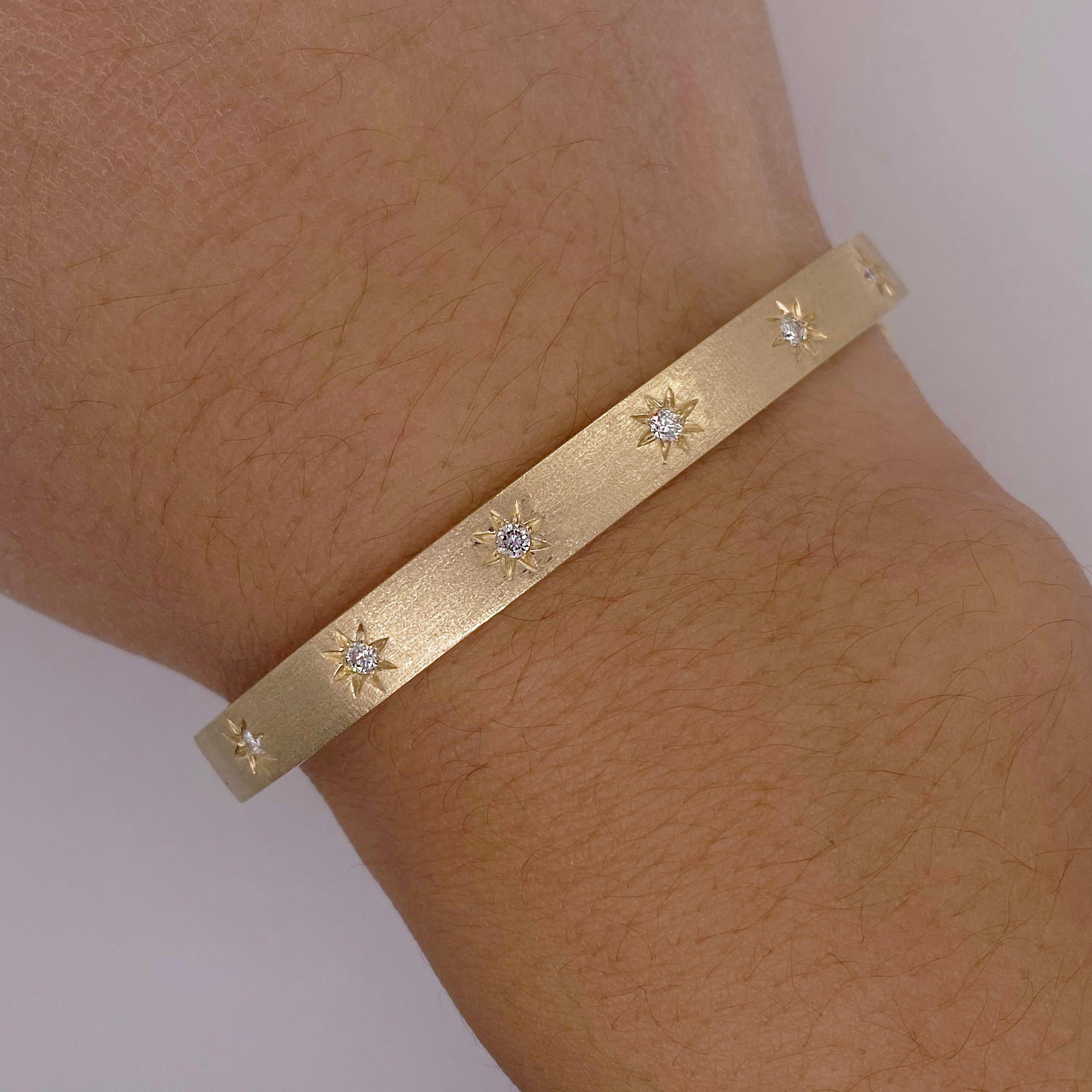 This starlight bangle is beautiful on its own, with other bangles, or next to a watch and created in recycled 14 karat yellow gold. It has a matching ring to make a lovely set. The diamonds are flush-set within the stars to make the bangle sparkle