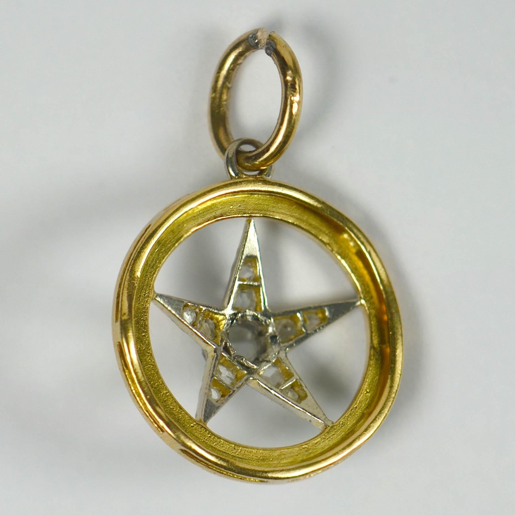 An 18 karat gold pendant charm designed as a green guilloche enamel circle with a platinum star. The five pointed star is set with rose-cut diamonds. 1/2