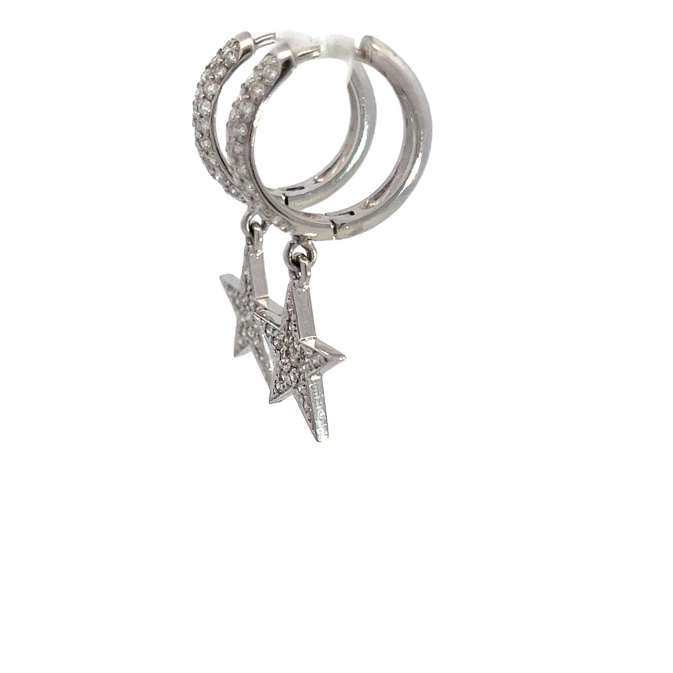 These exquisite 14k white gold hoop earrings feature a lively star-shaped diamond encrusted with sparkling diamonds, dangling elegantly from pavé diamond hoops. With a total diamond weight of 1.32 carats, these earrings capture light beautifully,