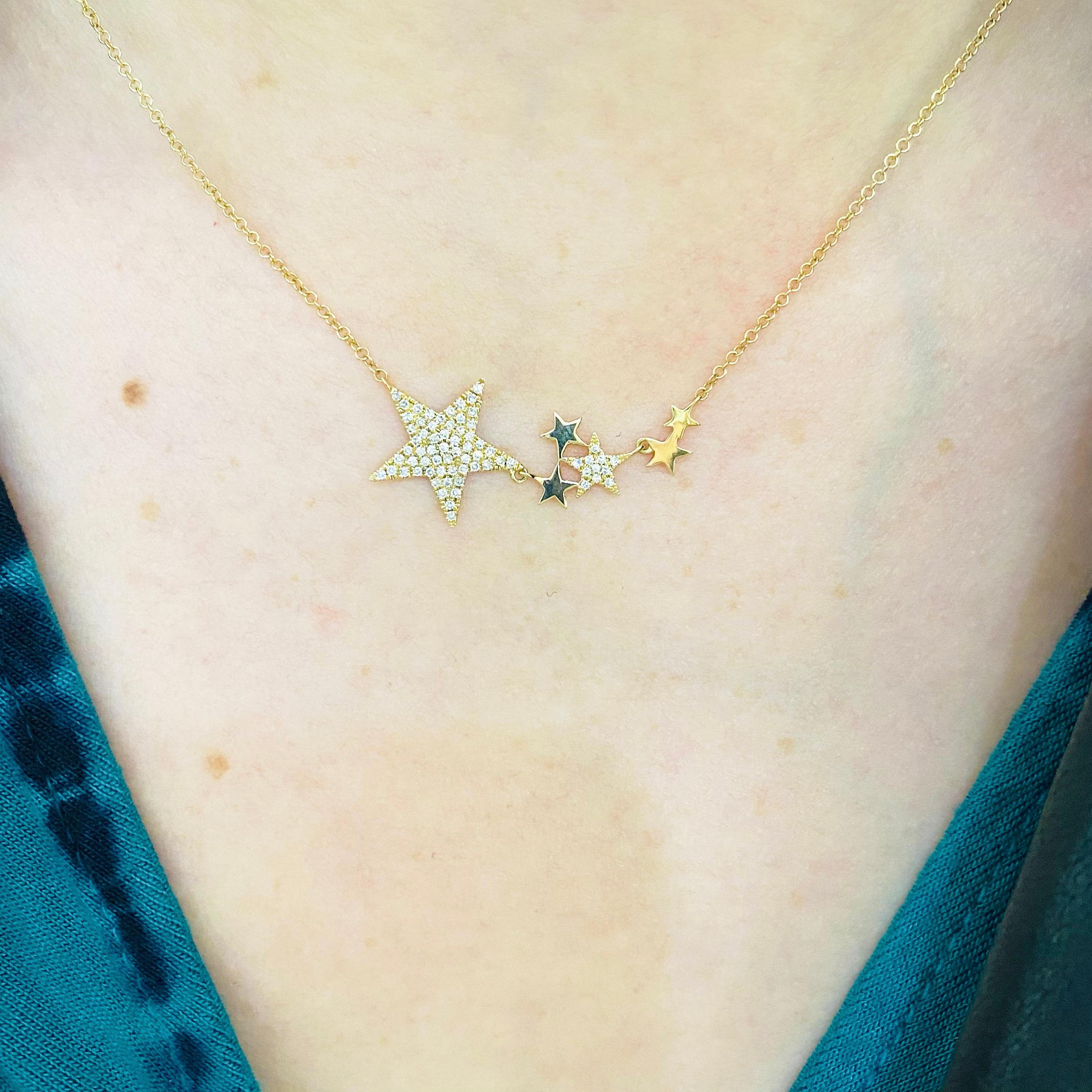 Catch a falling star!  This diamond star designer necklace is bold and beautiful! Made in 14K gold and sprinkled with genuine, natural diamonds. The necklace has a flexible star bar design with two of the brilliant stars paved with gorgeous white