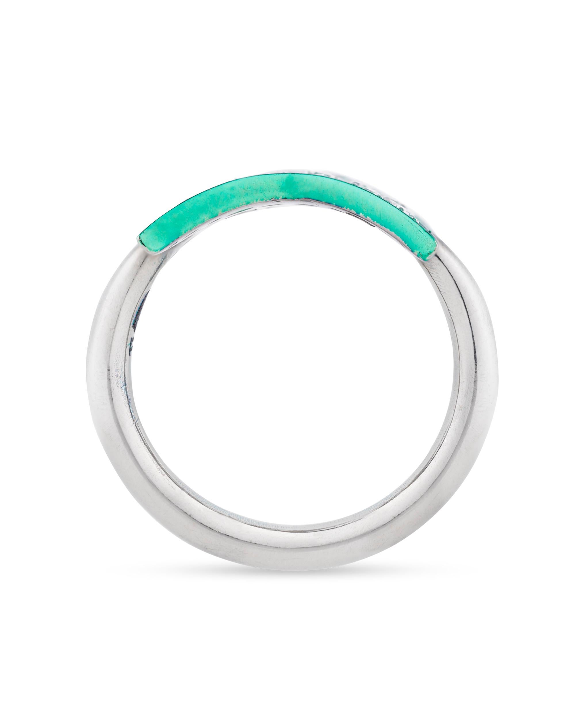 A vibrant green star encrusted with diamonds sits at the center of this 18K white gold and titanium ring. Diamonds totaling 2.68 carats are pavé set into the star form, lending it a bright sparkle rivaling the stars in the night sky