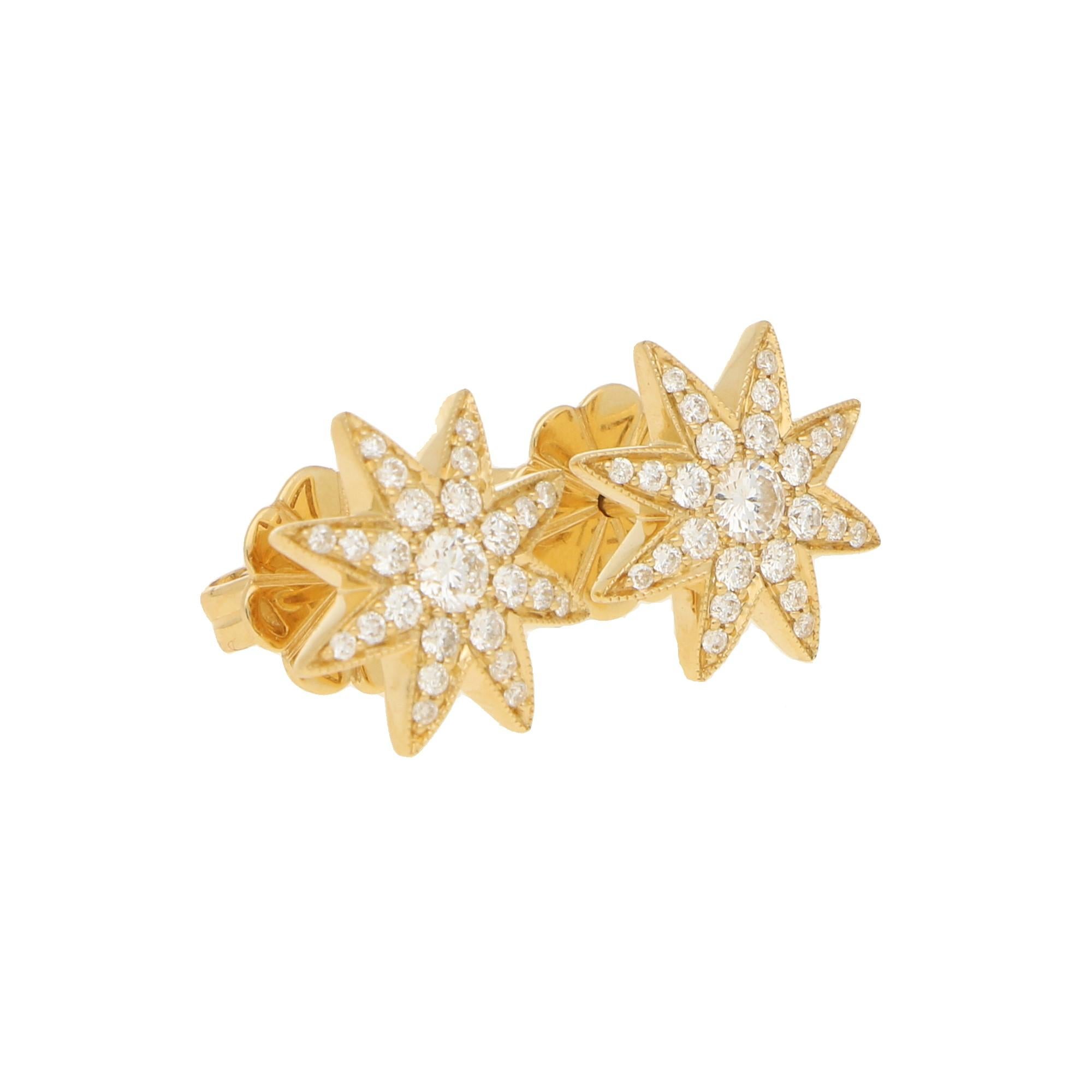 A pretty pair of 18ct yellow gold diamond set star shaped stud earrings. The stars are eight pointed, grain set with twenty five round brilliant cut diamonds of varying sizes, with a mille grain finish around the stars edge. 
Secured on a post with