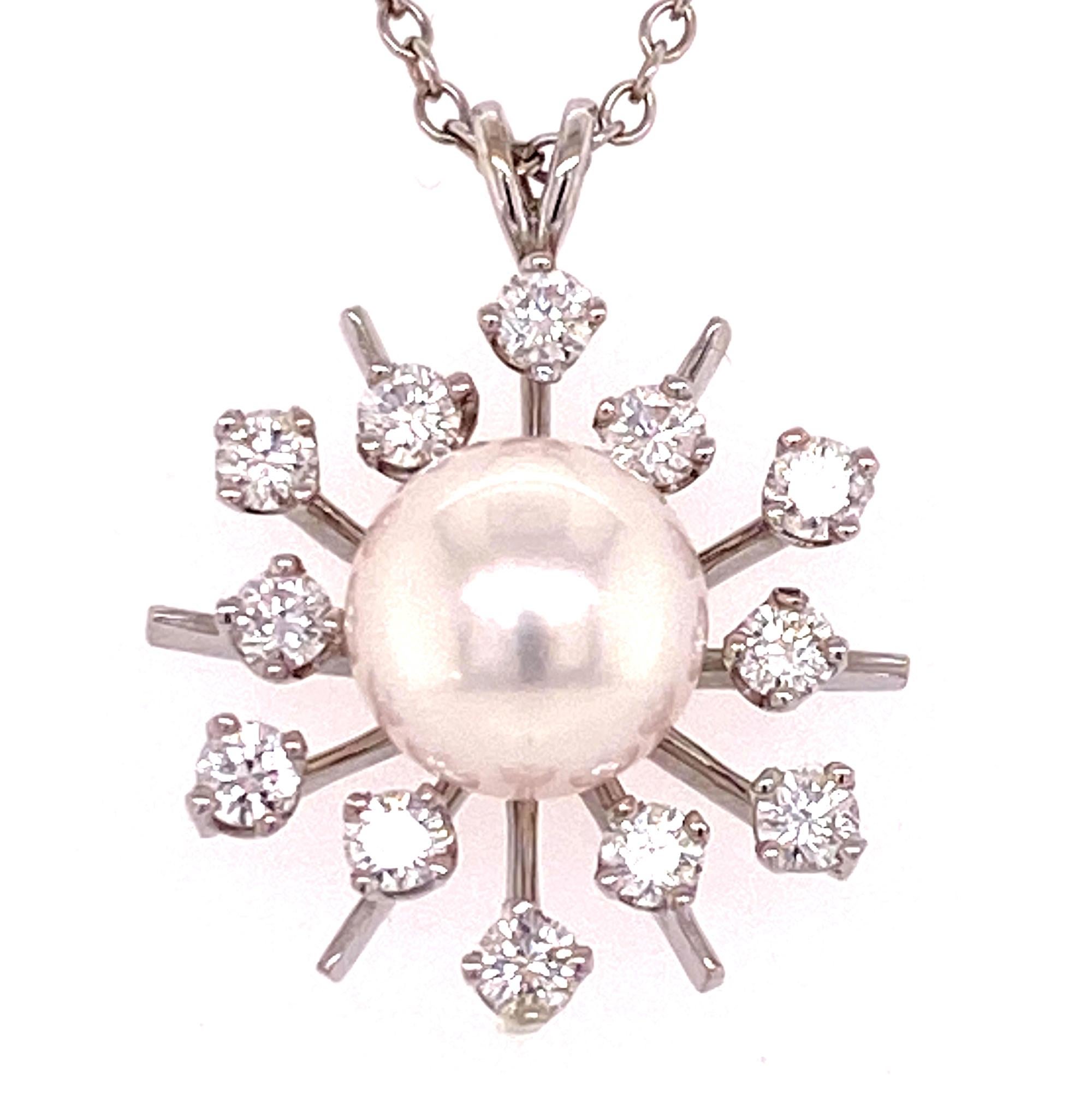Beautiful starburst diamond cultured pearl pendant fashioned in 14 karat white gold. The round brilliant cut diamonds weigh approximately .50 carat total weight and are graded F-G color and VS clarity. The pendant measures .75 x .75 inches and the