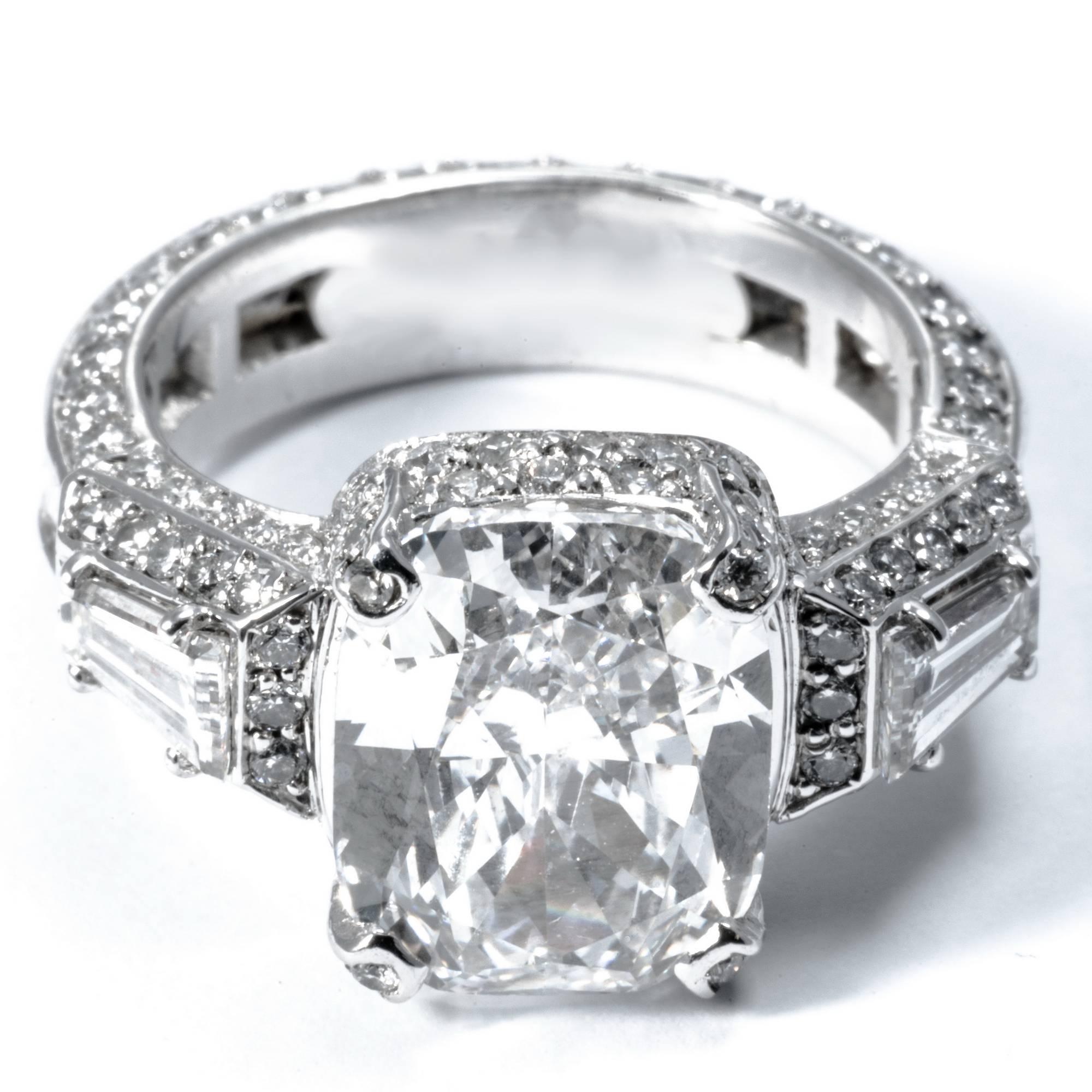 This statement  ring band is the perfect choice for diamond lovers. This rare and beautiful solitaire diamond is a cushion cut of 3.80 carats, E color.  Set in white gold 18k, the band is fully decorated with 124 extra white diamonds, featuring 2