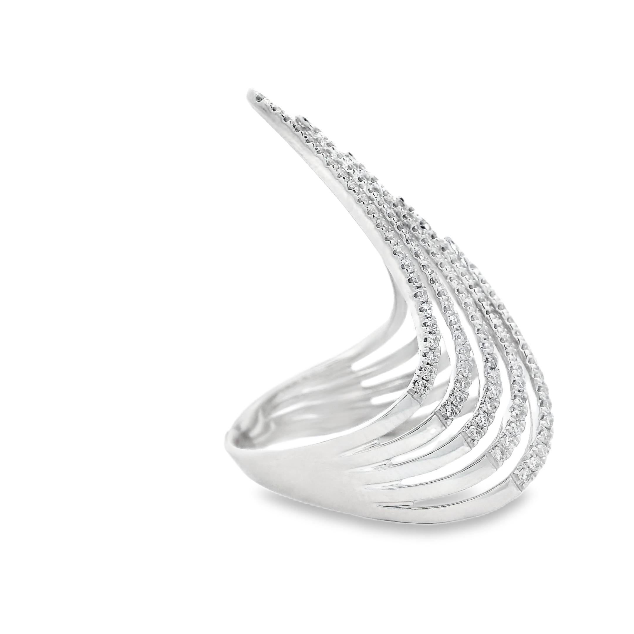 Bold and architectural, this diamond statement ring is crafted in rhodium-plated 14K white gold and set with 196 round brilliant-cut diamonds. The design fans out in a dramatic V-shaped silhouette, with seven curved rows of diamonds rising to a