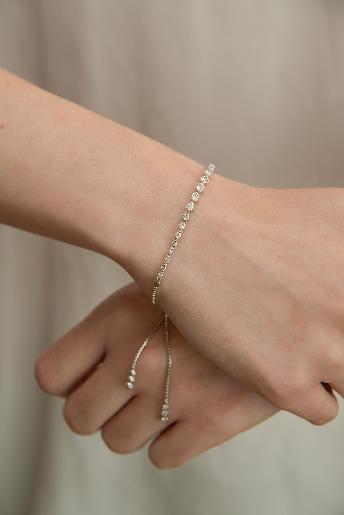 A new twist on the diamond tennis bracelet. The Diamond string bracelet featuring 1.25 brilliant cut diamonds in 18k white gold with geometric clasp.
Adjustable sizing