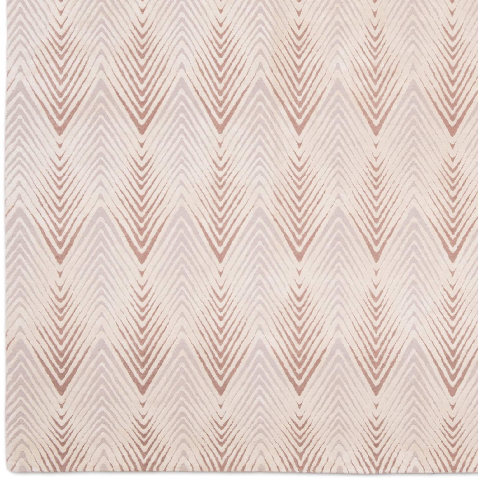 'Diamond Stripe' is from the knots rugs new 2018 collection. This rug is produced in 150 knot quality in a high low pile. The chevron design is raised and in Chinese silk and the blush and soft mauve background is a lower pile in Tibetan wool. Also