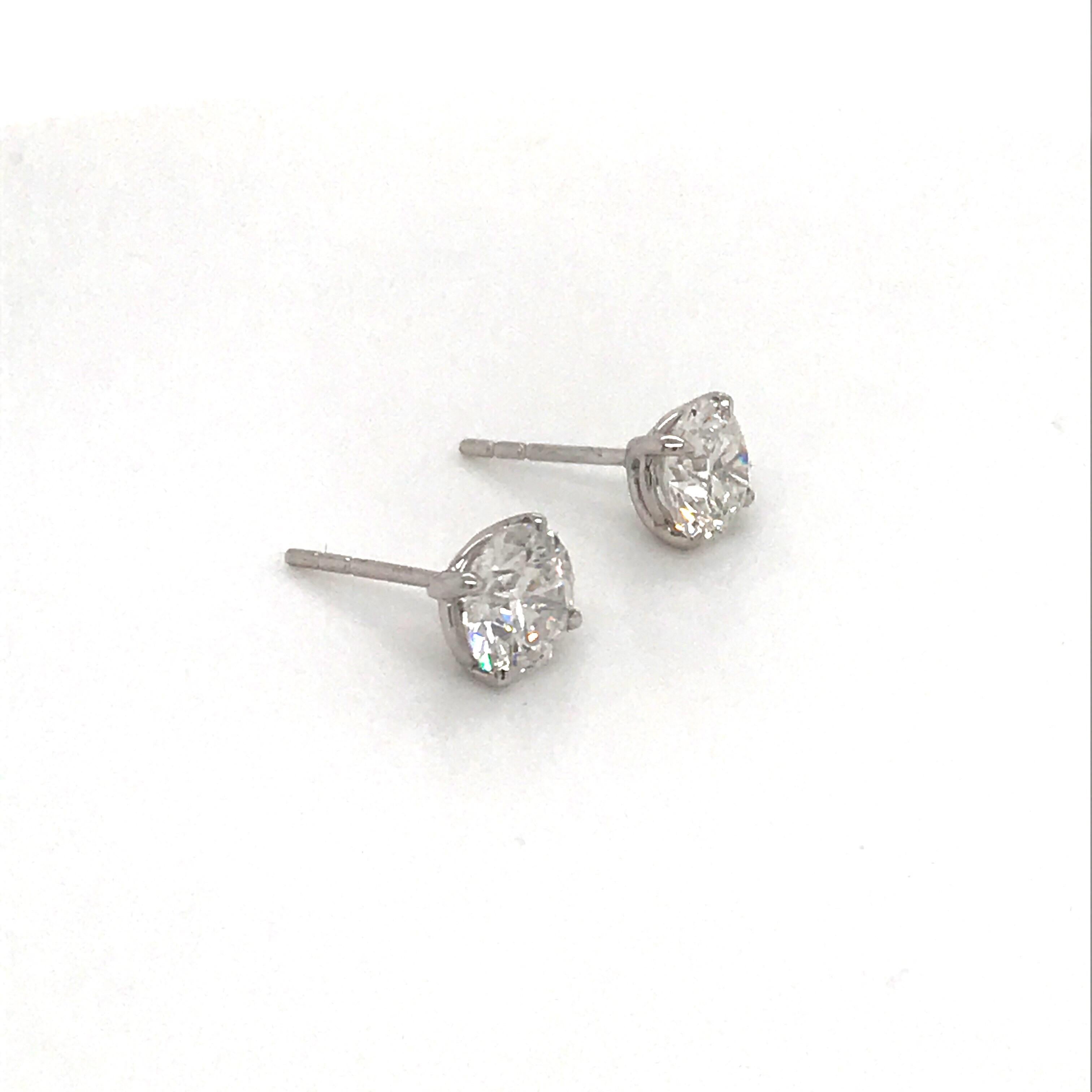 Diamond stud earrings weighing 1.42 carats in a 4 prong martini setting, 14k white gold. 
Color F-G
Clarity I1

Beautiful brilliance. 