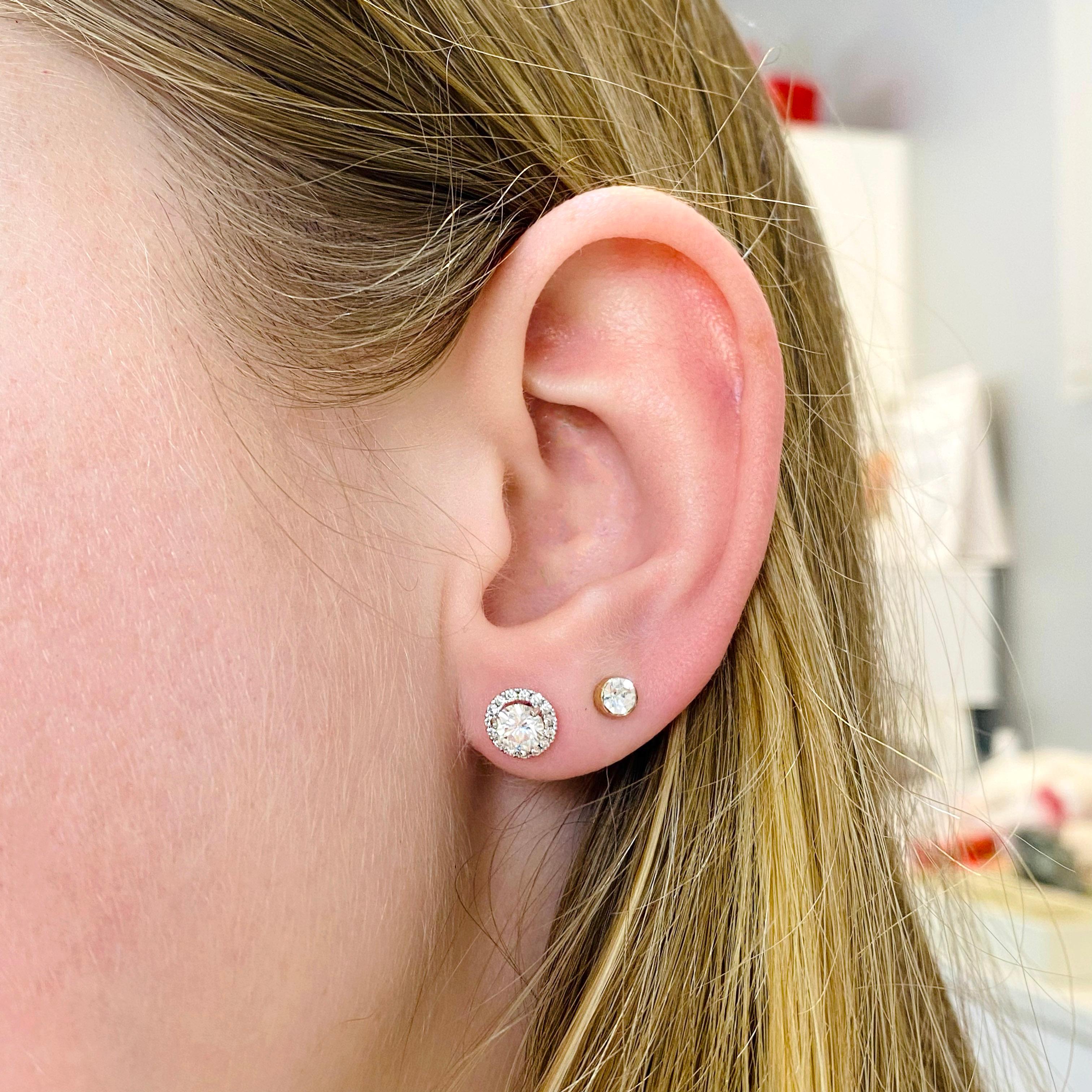 These classic diamond studs have a diamond halo that makes them appear even bigger and more stunning. These are the necessary piece for every jewelry collection. Every woman wants a pair of diamond earrings! The details for these gorgeous earrings
