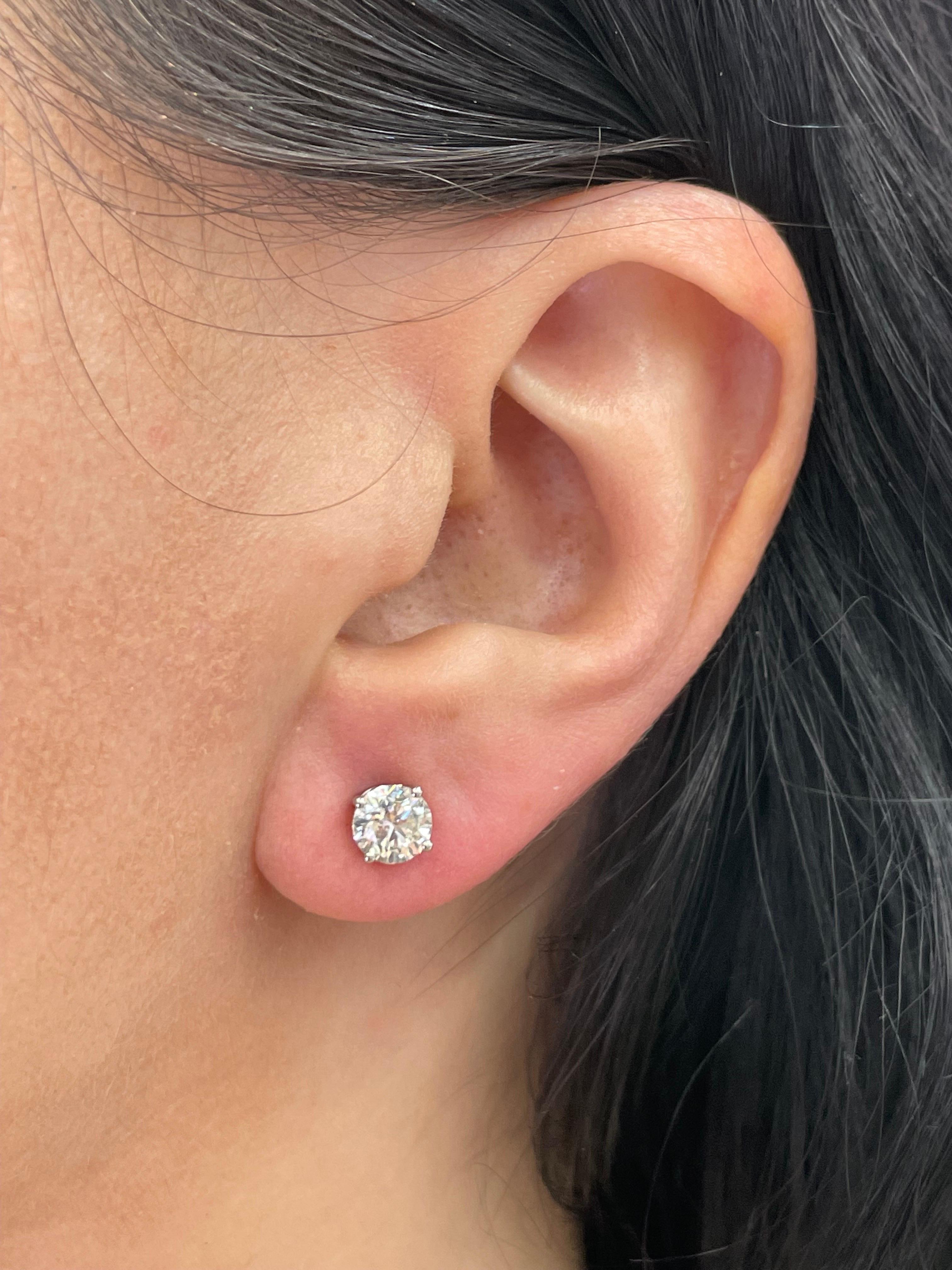 Diamond stud earrings weighing 1.60 Carats, Color L, Clarity SI1-SI2, in 14 Karat White Gold 4 prong Basket setting. 
Faces up as an I Color, Nice Life to Stones
Setting can be changed to a Basket, Martini or Champagne/ 3 or 4 Prong/ 14 or 18