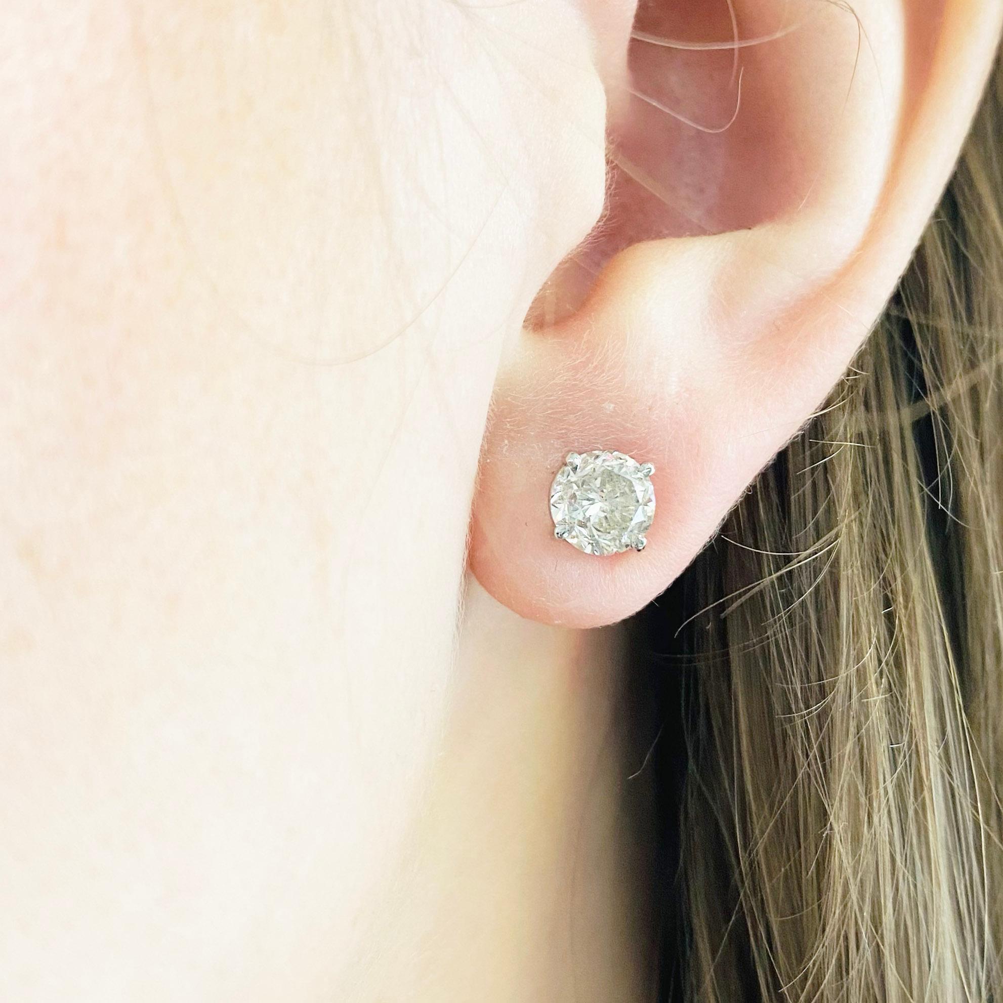 These stunning 14k white gold round diamond stud earrings provide a look that is both trendy and classic. These diamond earrings are a great staple to add to your collection, and can be worn with both casual and formal wear.  These earrings would