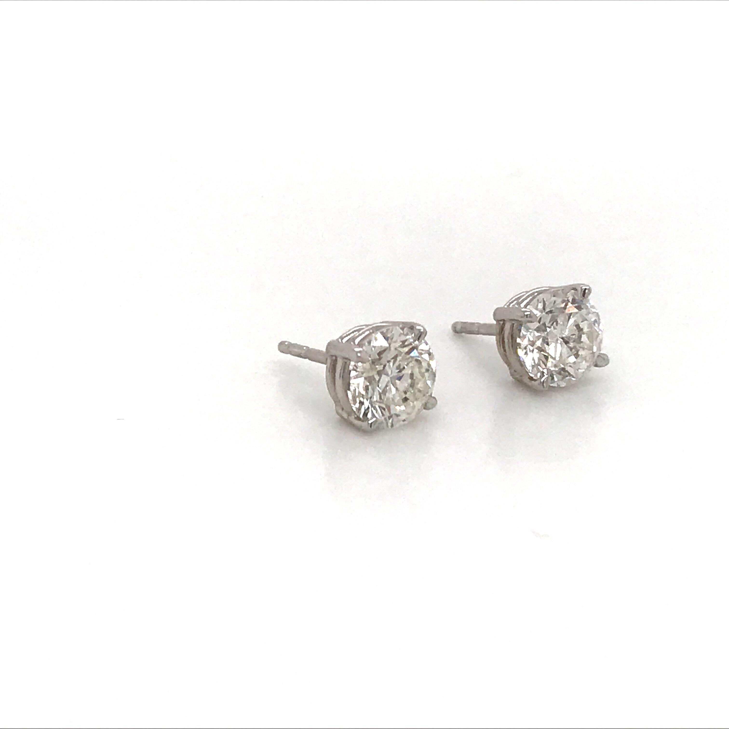 14K White gold diamond stud earrings weighing 1.80 carats in a 4 prong classic setting. Settings can be switched to martini or champagne. 
Color I-J
Clarity SI1

Brilliant pair of studs. 