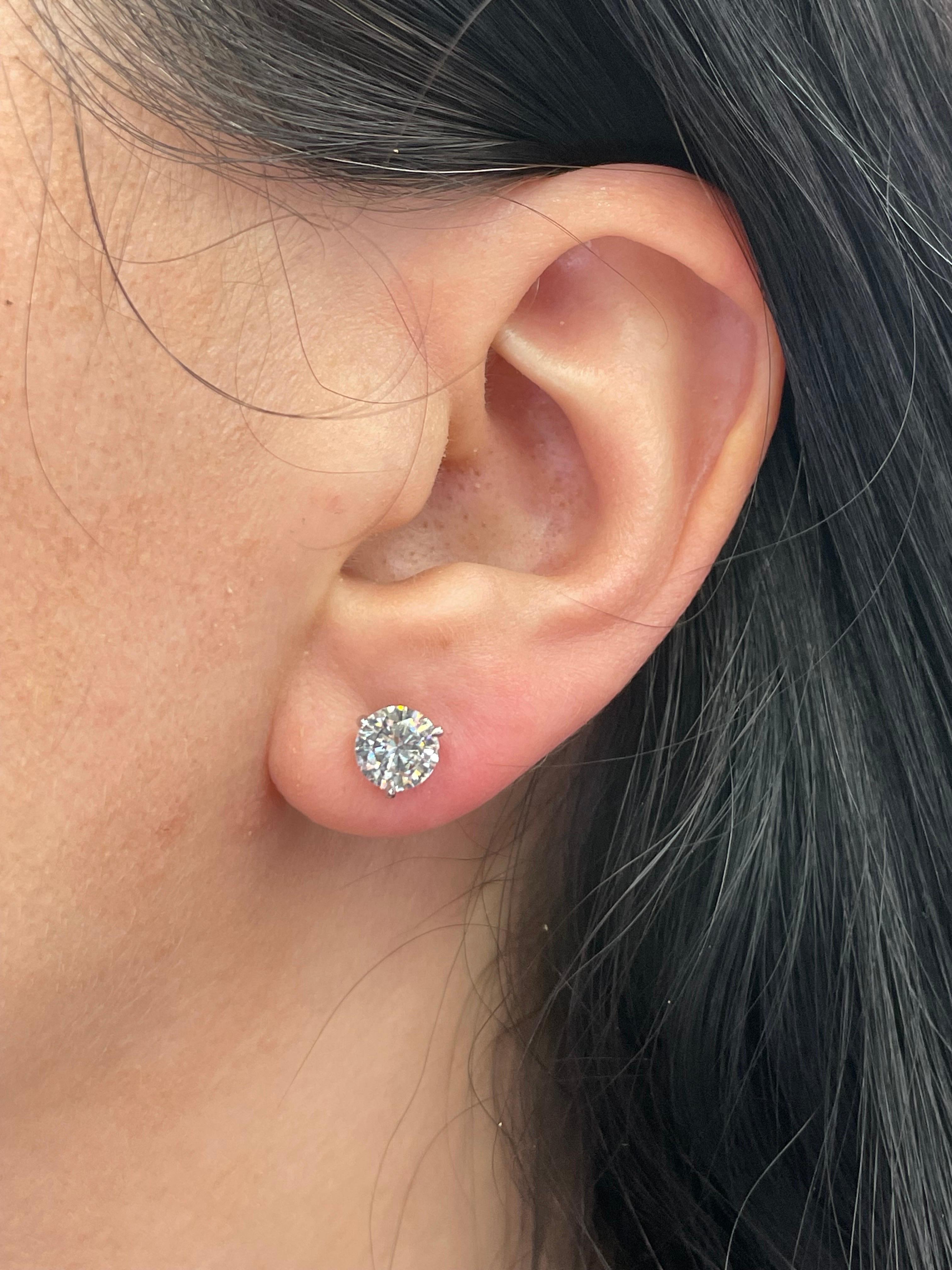 Diamond stud earrings weighing 2.09 Carats, Color H, Clarity I1, in 18 Karat White Gold 3 prong Champagne setting. 
Nice Life & Clean to the Eye
Setting can be changed to a Basket, Martini or Champagne/ 3 or 4 Prong/ 14 or 18 Karat.

DM for more