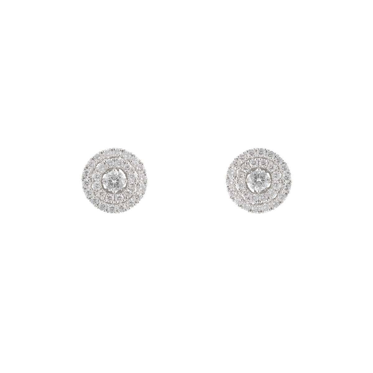 A stylish pair of 18k white gold earrings. The earrings are set with round brilliant cut diamonds in a double halo with a single solitaire in the middle totalling to an approximate weight of 2.24ct. The earrings are prong set with push butterfly